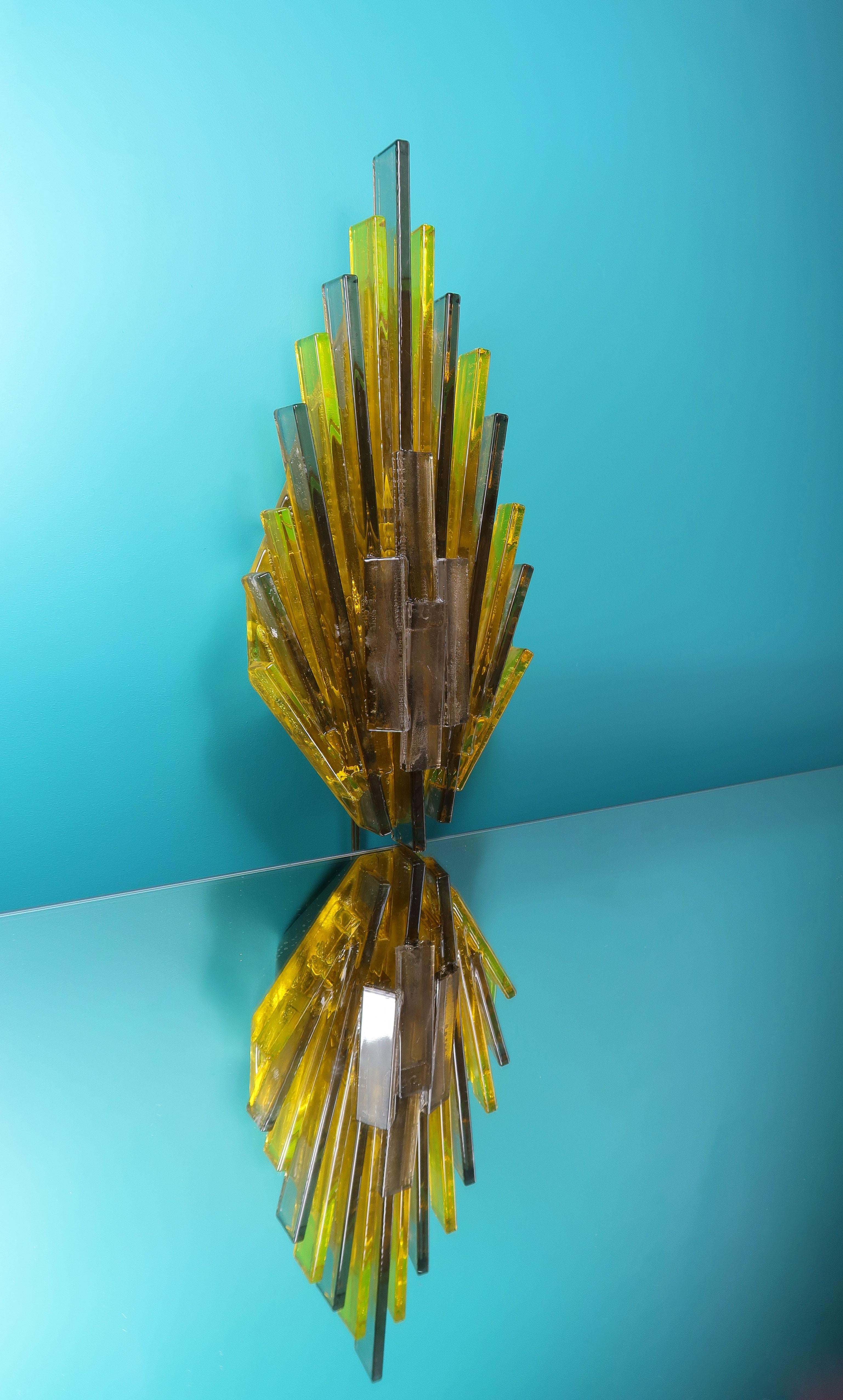 Spectacular Danish Mid-Century Modern atomic age wall light consisting of rectangular sticks of yellow and smoke colored acrylic resin creating a sculptural flame like wall light. By Danish designer and flight engineer Claus Bolby for CeBo Industri