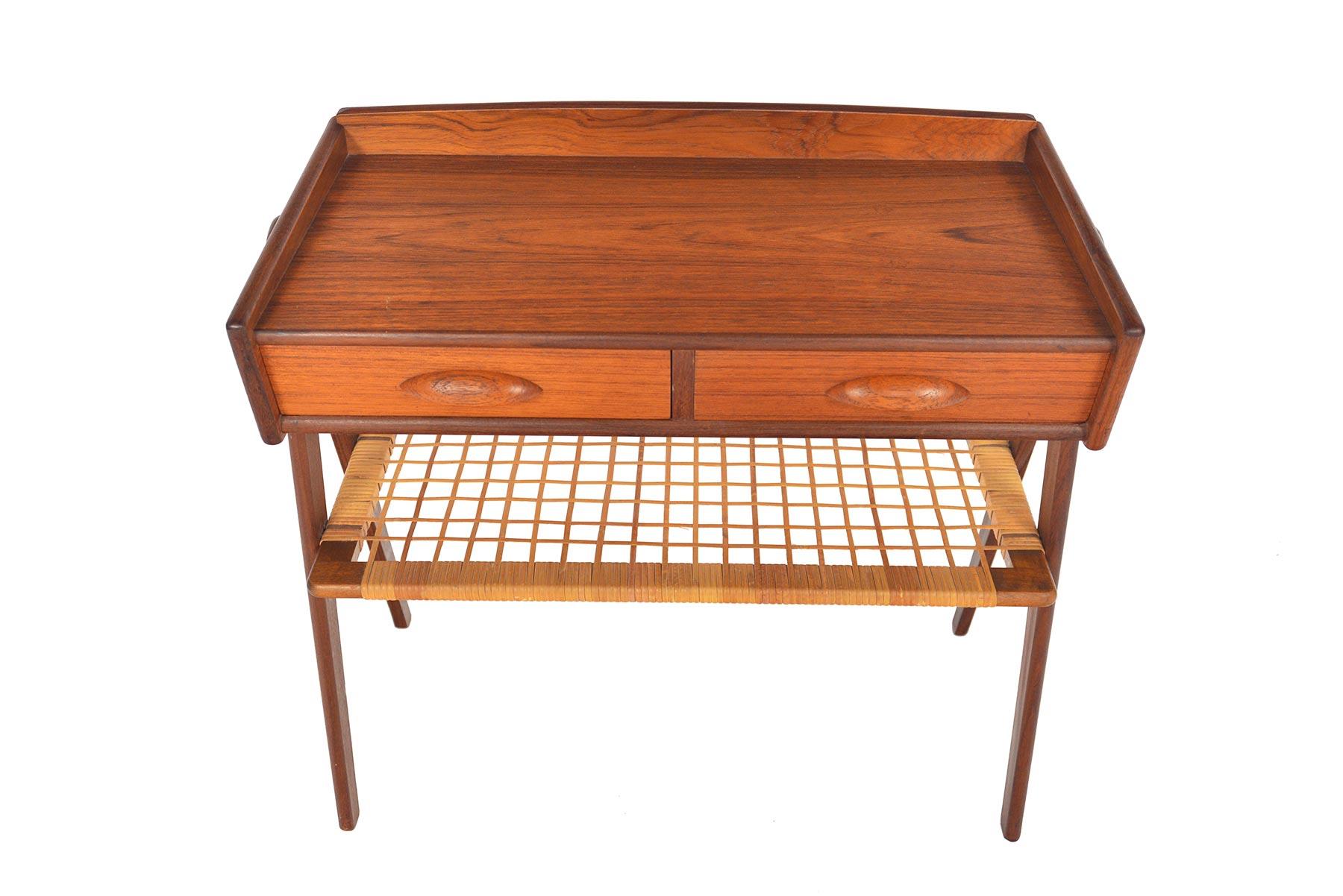 Designed by Søren Rasmussen in the 1950s, this stunning Danish modern nightstand is a true statement piece! Supported by two exterior v-legs, this case features two drawers and cane rack. In excellent original condition.

 