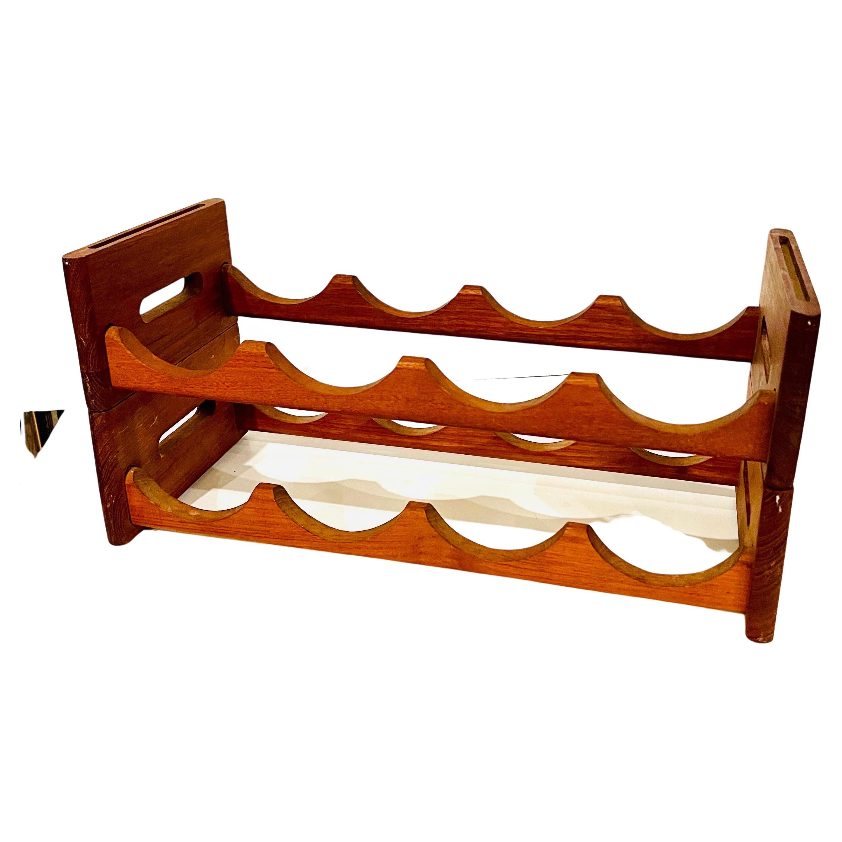 Midcentury stackable solid teak wine rack by Kalmar Designs, circa the 1970s. This double rack can hold up to 8 bottles and can be used one on top of the other or side by side.