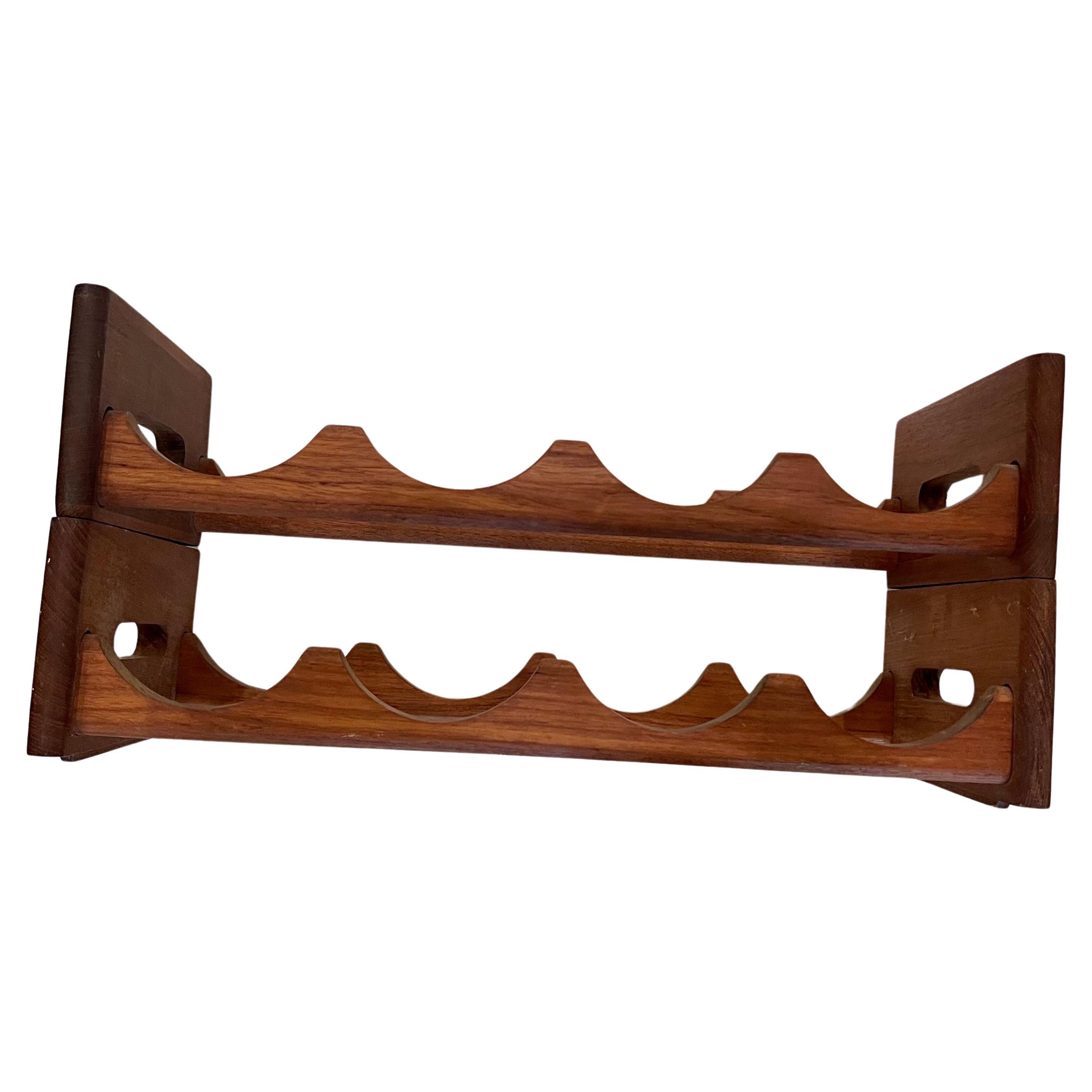 Midcentury stackable solid teak wine rack by Kalmar Designs, circa the 1970s. This double rack can hold up to 8 bottles and can be used one on top of the other or side by side.