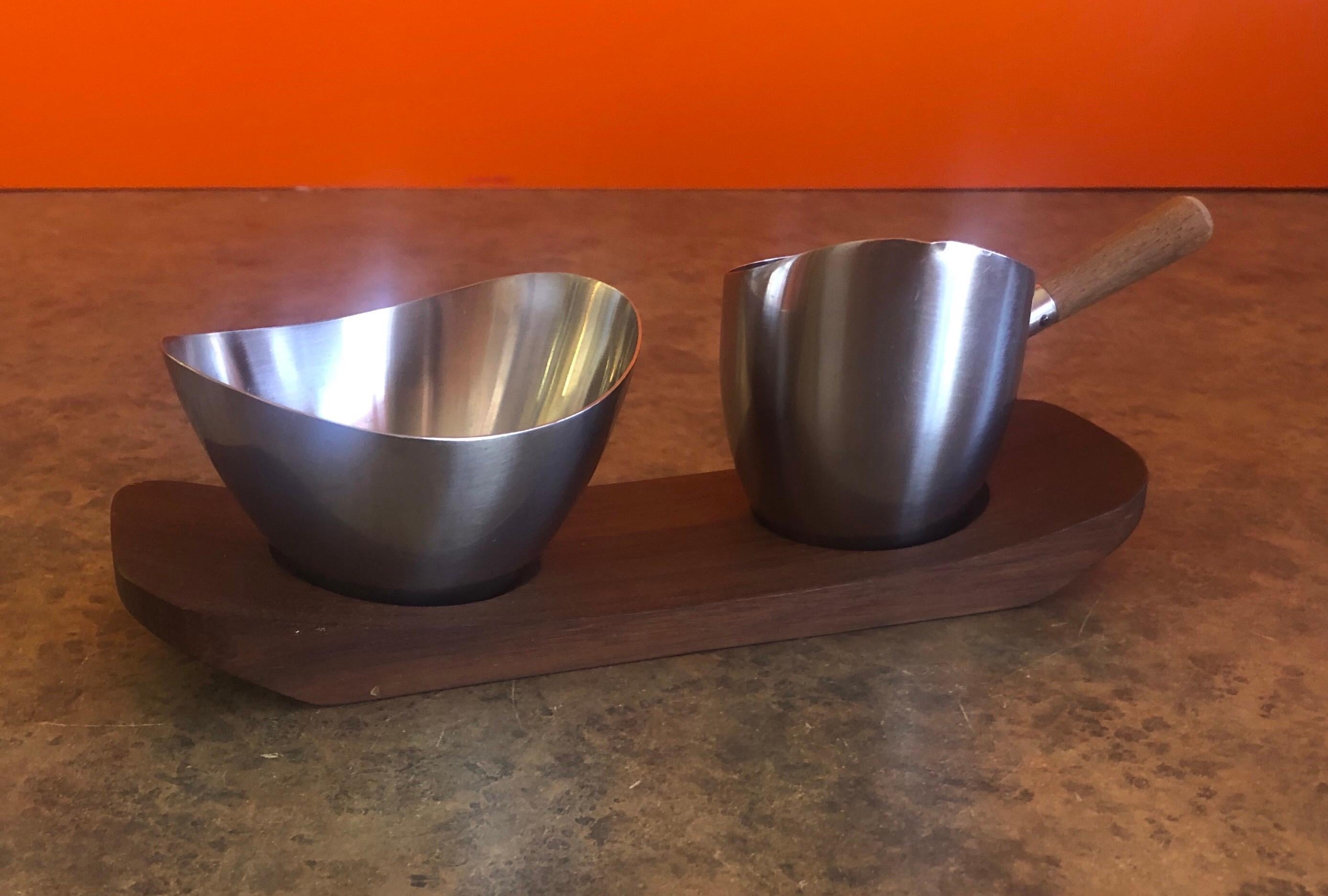 Danish modern stainless steel cream and sugar set on teak tray, circa 1960s. #1073.