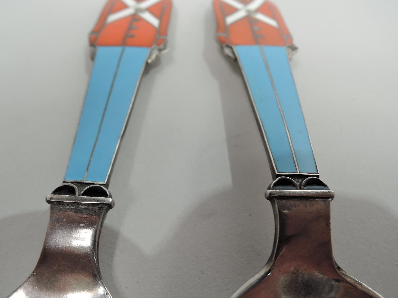 Novelty sterling silver youth set comprising fork and spoon. Each: Flat and figural with enameled royal guardsman terminating in bearskin. Traditional sentries to ensure a clean plate. Back plain. Fork has 4 tines and spoon has oval bowl. Fully