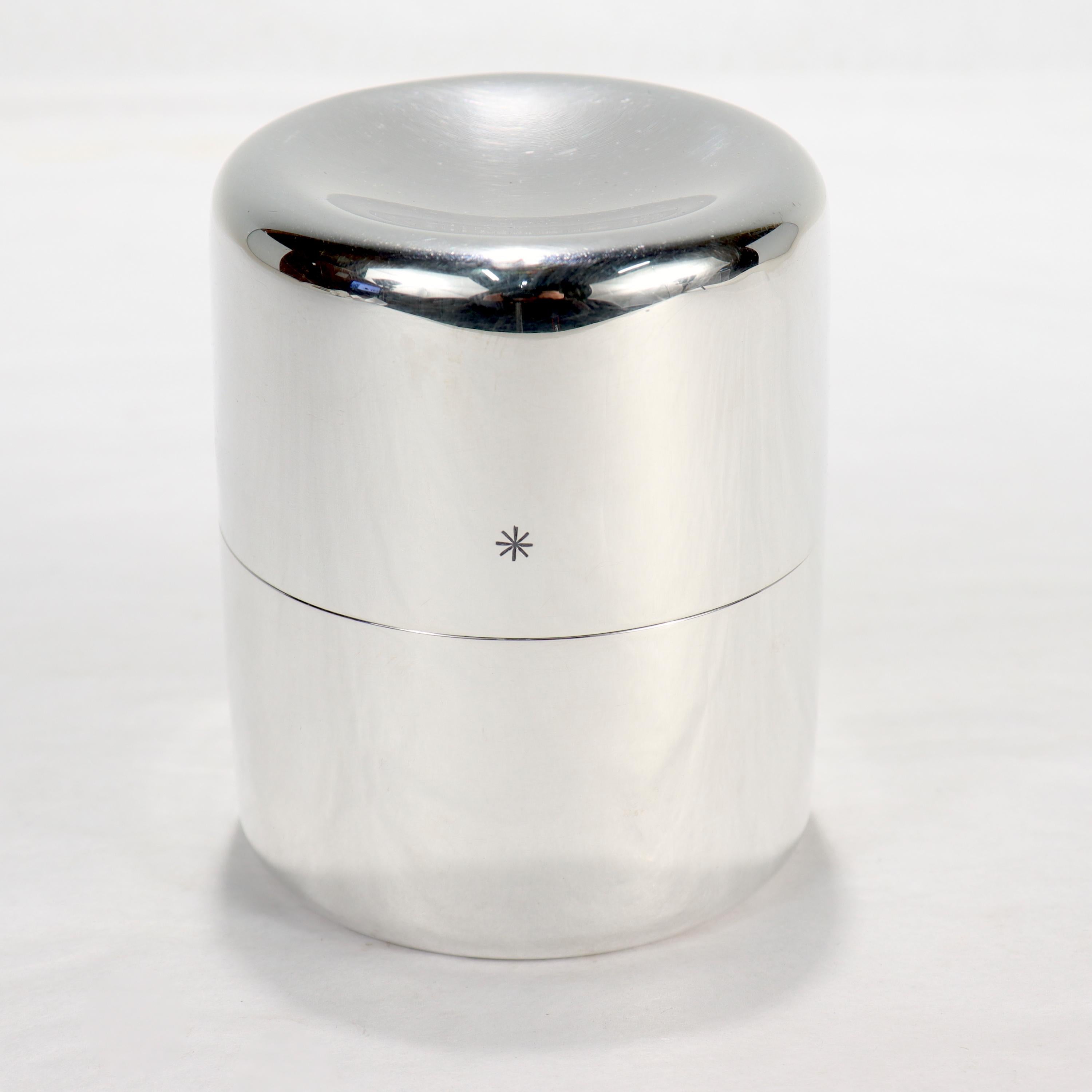 A fine Danish sterling silver tea caddy or covered box.

In sterling silver.

Designed by Ibi Trier Morch for Anton Michelsen.

With a recessed lid & base, sloped shoulders, equally proportioned top & bottom, and a star device engraved to the