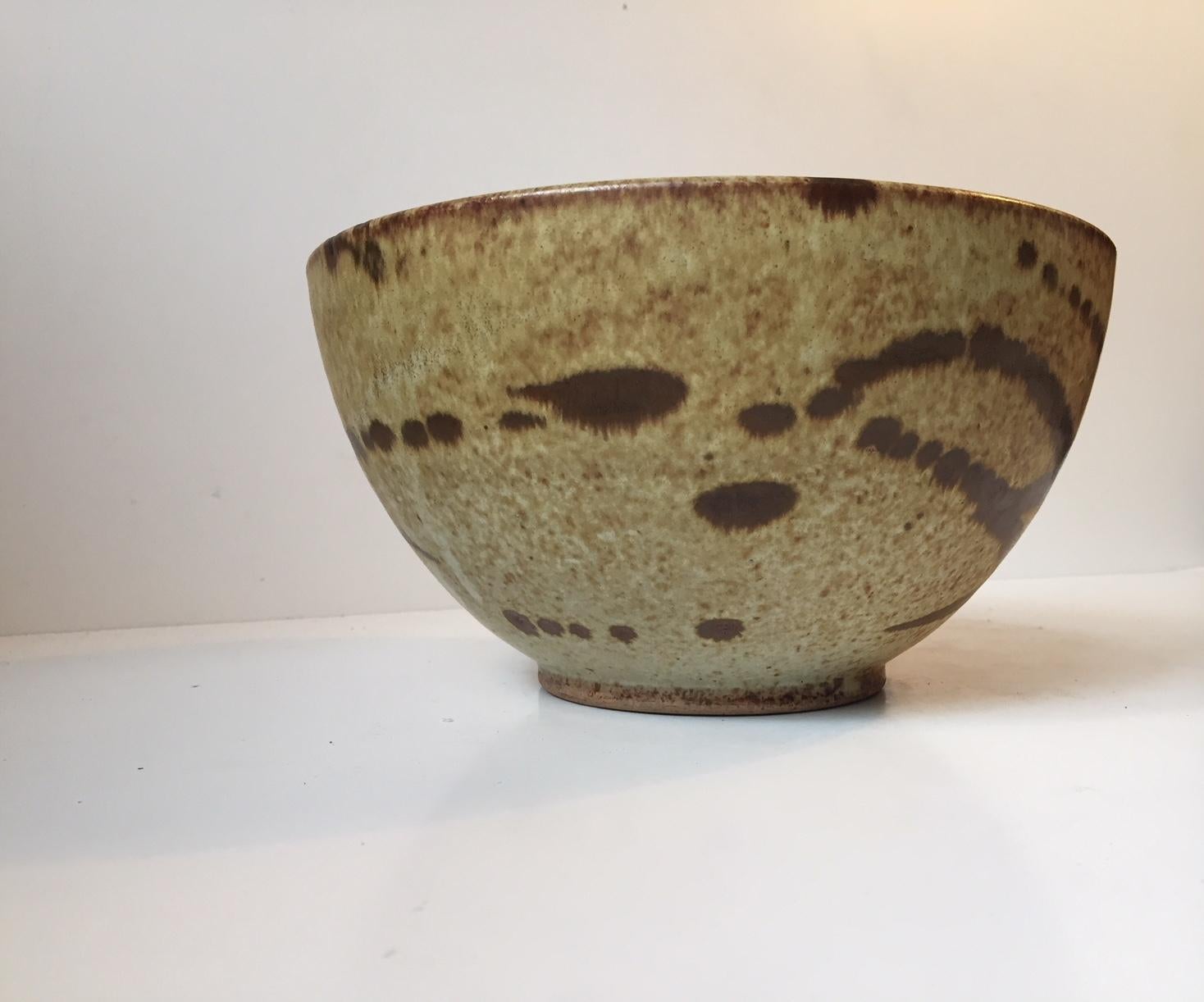 Uniquely decorated stoneware bowl in earthy glazes by the Danish ceramist Aage Würtz. Designed and created at his own studio in Copenhagen during the 1970s. Its signed to the base.
