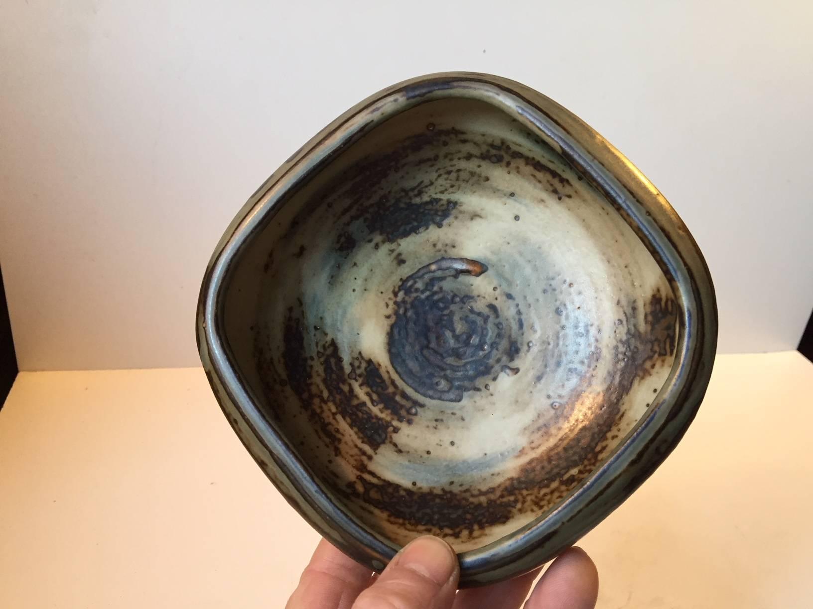 Organically shaped stoneware bowl in earthy sung and crystaline glazes. It was designed by Danish ceramist Bode Willumsen and manufactured by Royal Copenhagen in the late 1940s or early 1950s. Design number 20161.
Early on in his career Bode