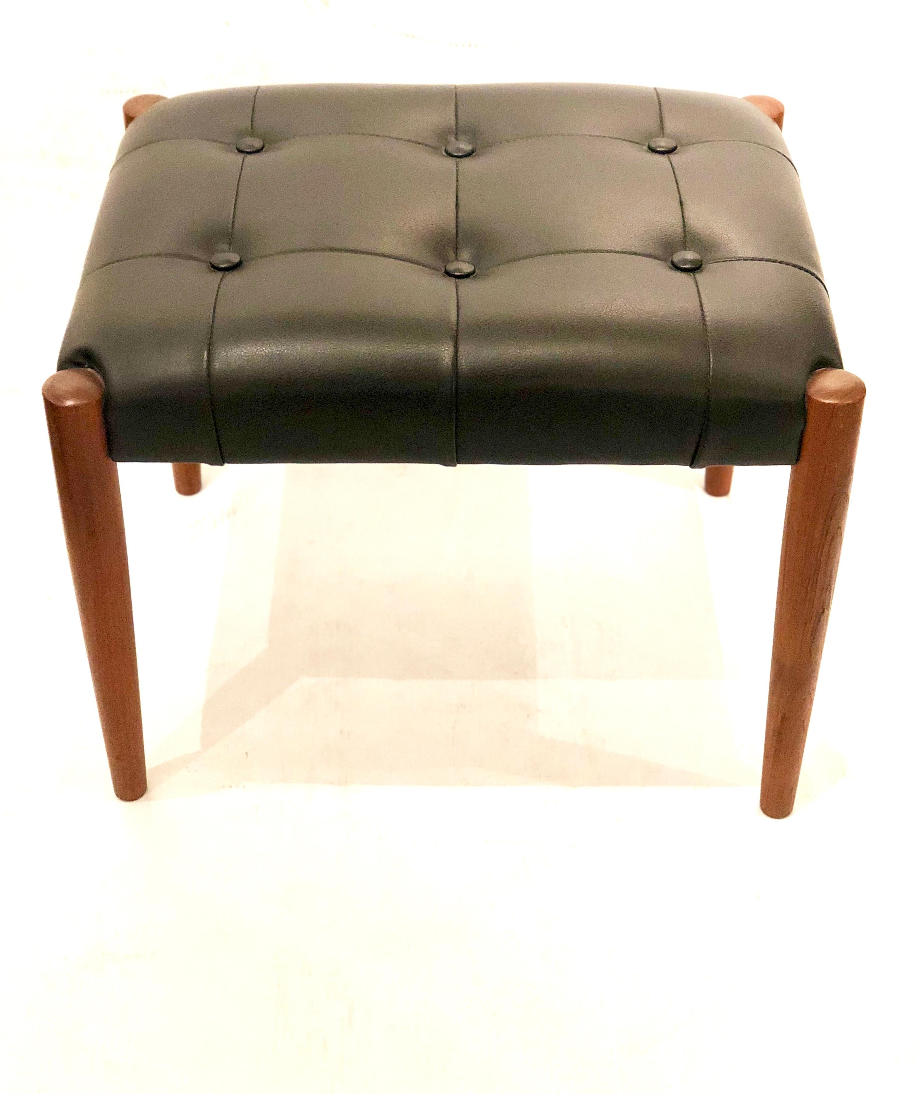 Versatile Danish stool in tufted top in black naugahyde with solid teak legs, circa 1950s solid and sturdy in original fabric nice condition.