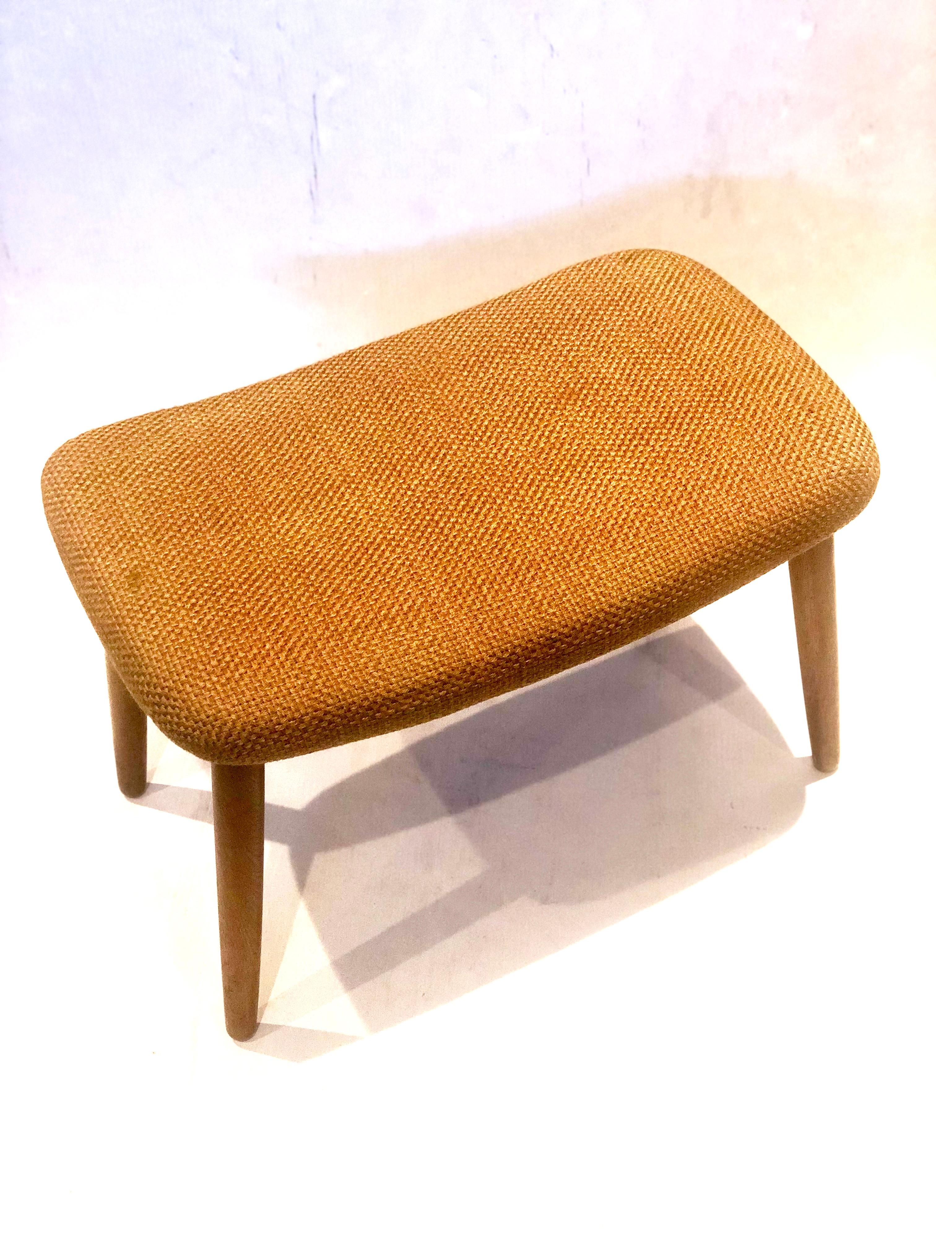 Nicely upholstered Danish stool in its original fabric, solid oak legs, solid and sturdy all original condition with light wear, circa 1950s.