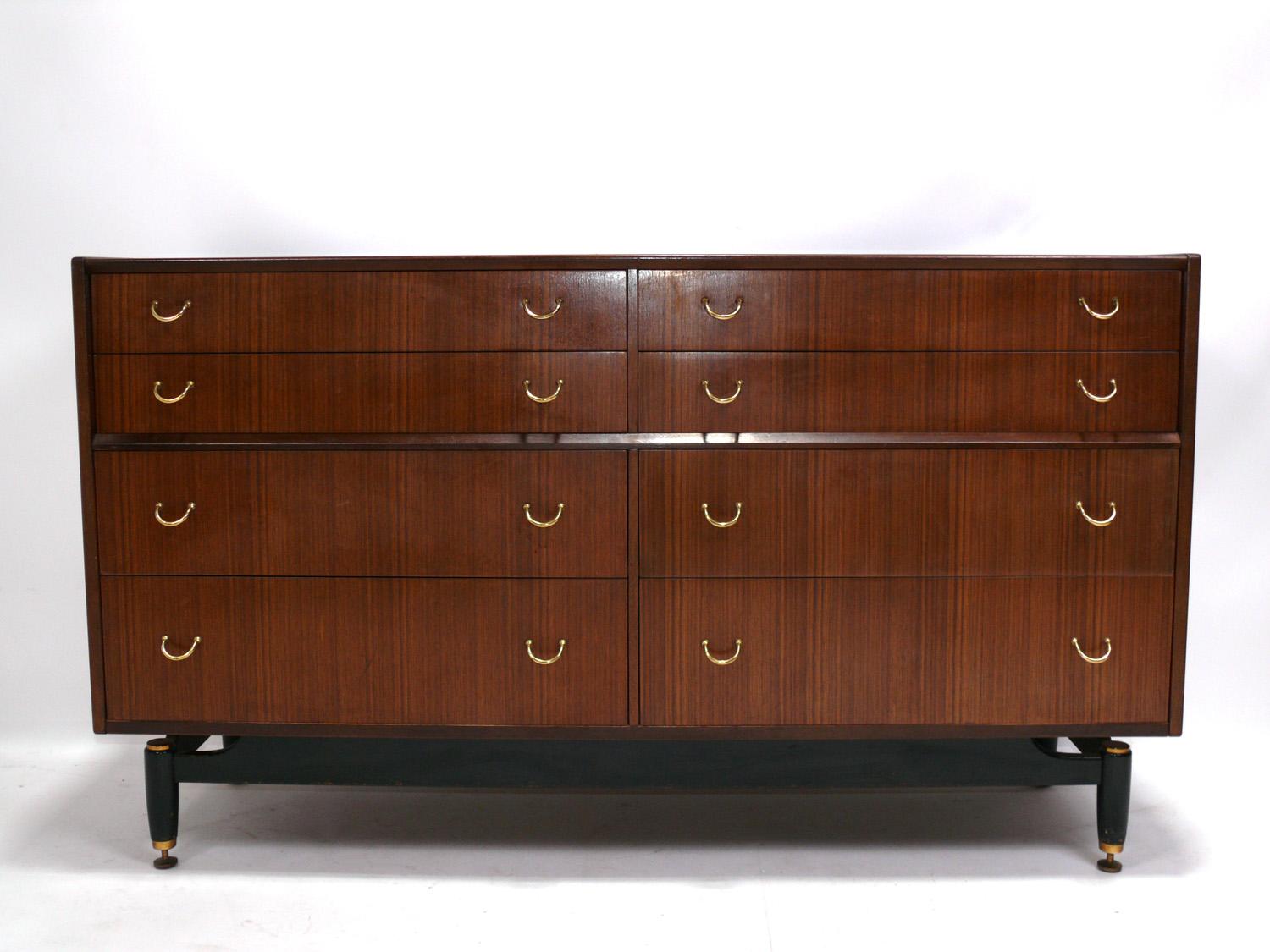 Danish Modern style chest or dresser, made by G Plan Furniture, England, circa 1960s. While located in England, G Plan's designs were clearly influenced by Danish Modern design of the era. This chest offers a voluminous amount of storage with 8