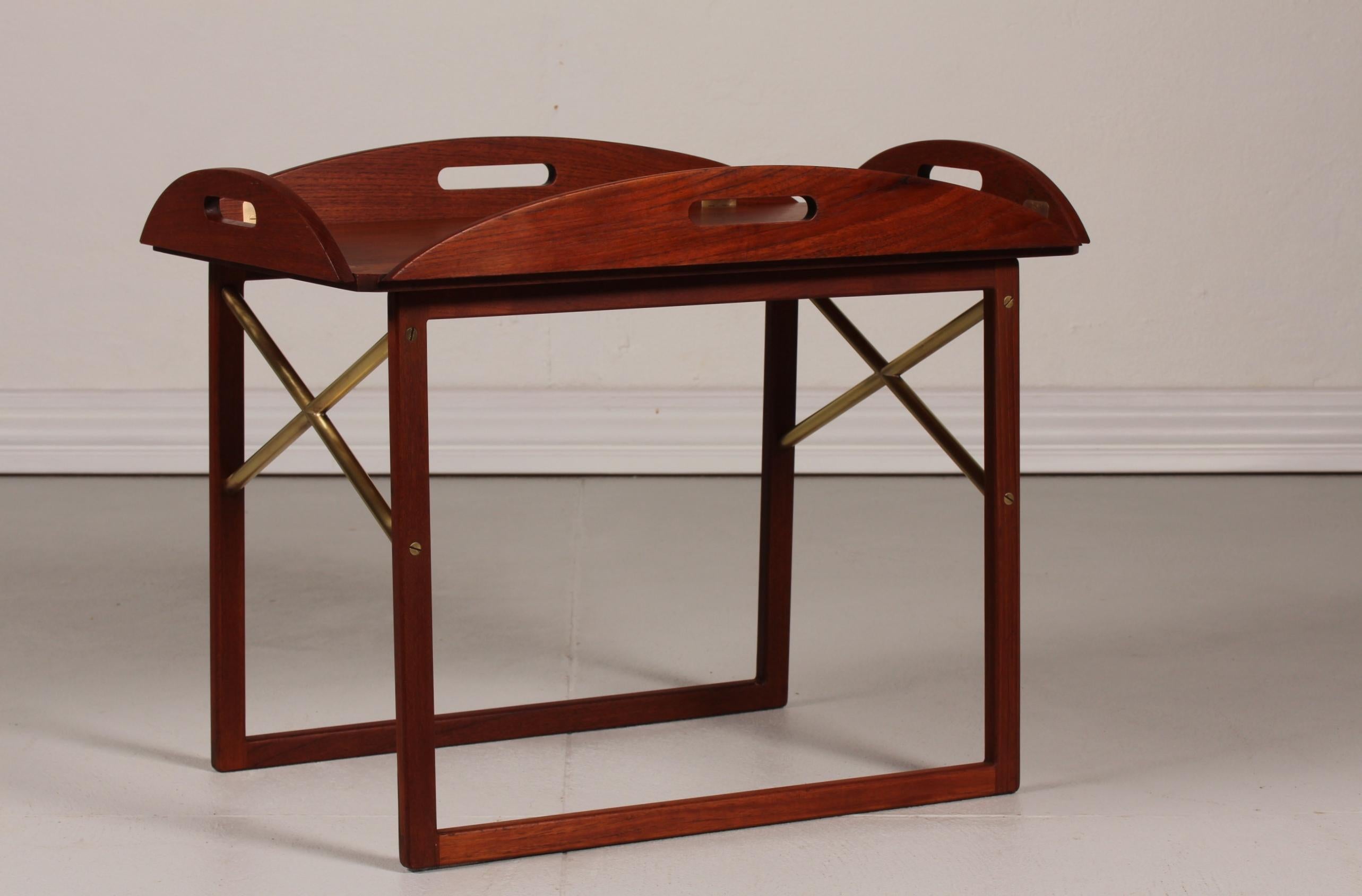 Butlers tray designed by Svend Langkilde made of teak with oil treatment and with hinges and parts of the under frame of brass.
It is possible to use the tray separately, as the tray and the frame are made in 2 sections.
Made for Illums Bolighus