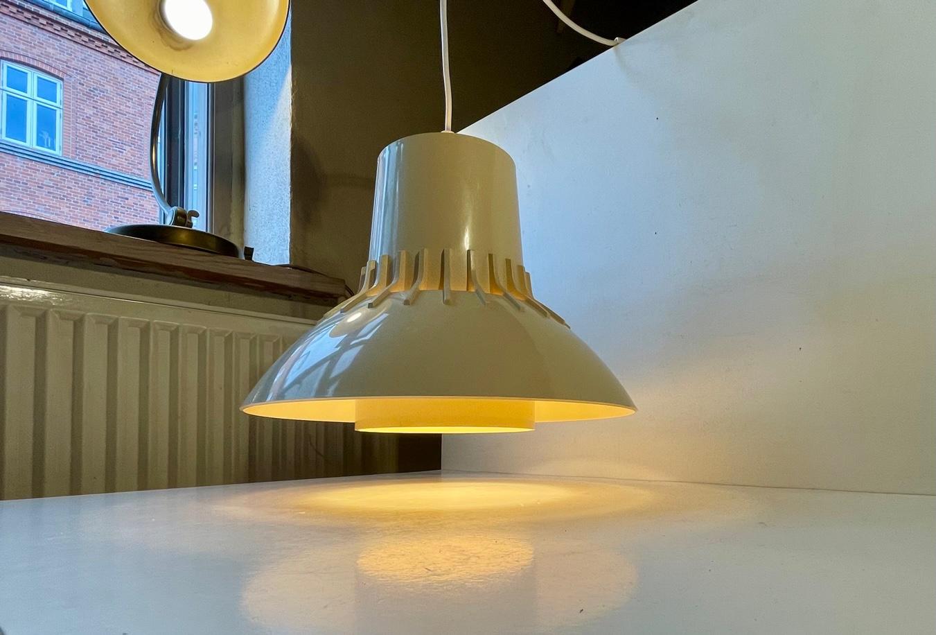 Cream-colored acrylic hanging light featuring perforations and light distributing inner shade. It was designed by Svend Middelboe in Denmark and manufactured by Nordisk Solar.Reminiscent in style to similar lights from Yasha Heifetz for French