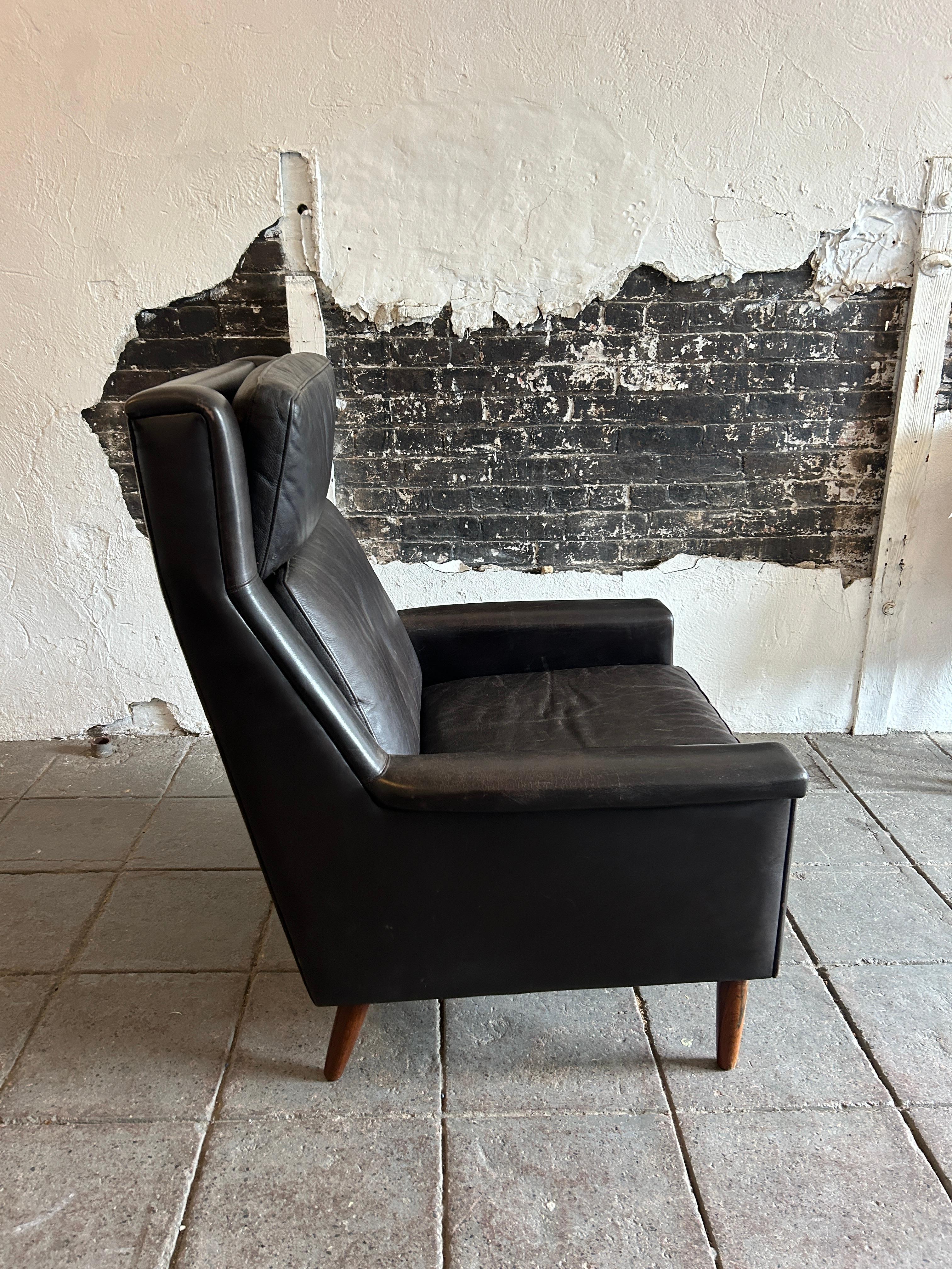 Danish Modern Svend Skipper high back dark brown Leather Lounge Chair. Beautiful soft leather with rosewood tapered legs. Color is a very dark brown. Great condition ready for use. Made in Denmark - located in Brooklyn NYC.

H 40