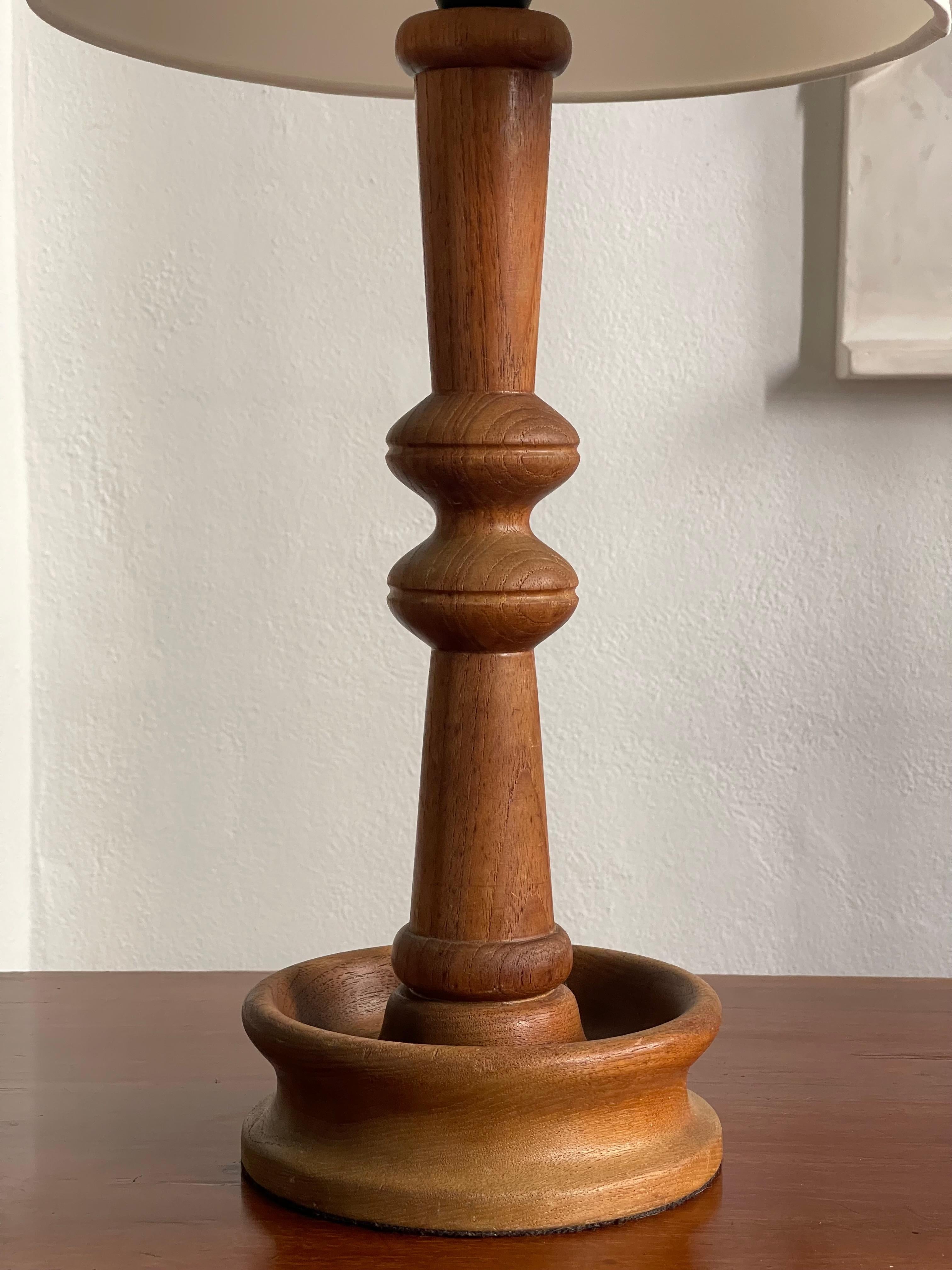 Hand-Carved Danish modern table lamp in one solid piece of carved teak wood. Denmark 1950s For Sale