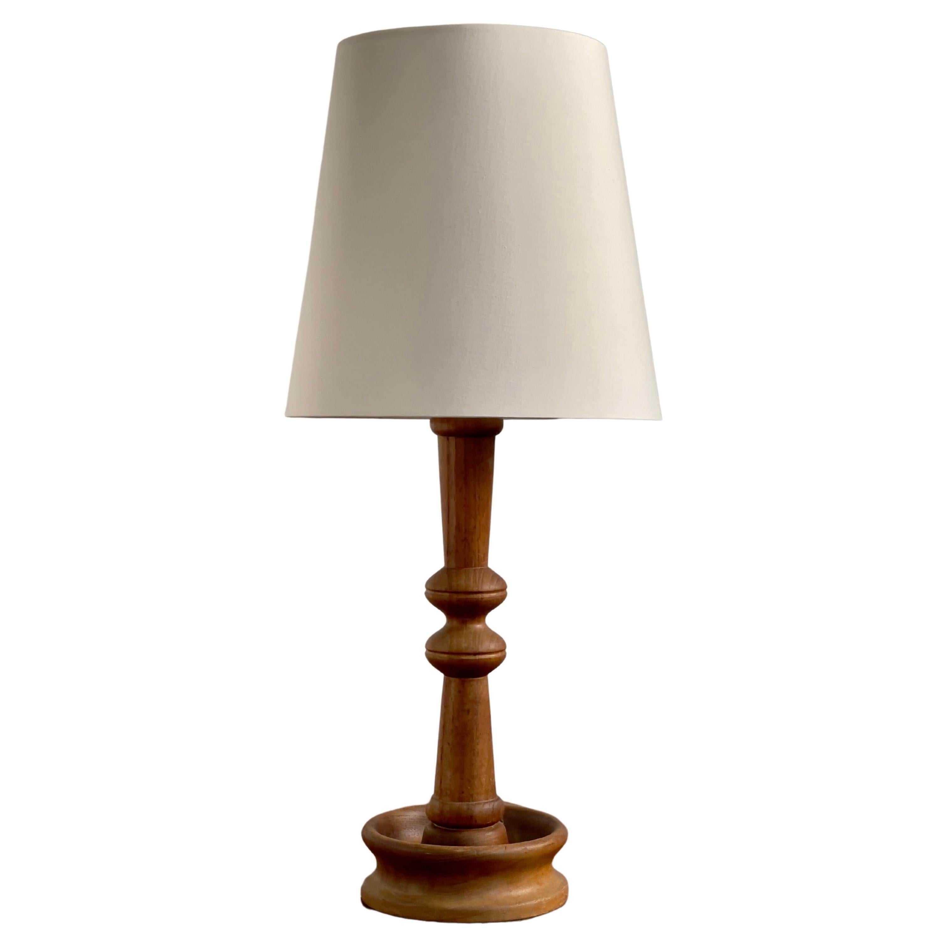 Danish modern table lamp in one solid piece of carved teak wood. Denmark 1950s