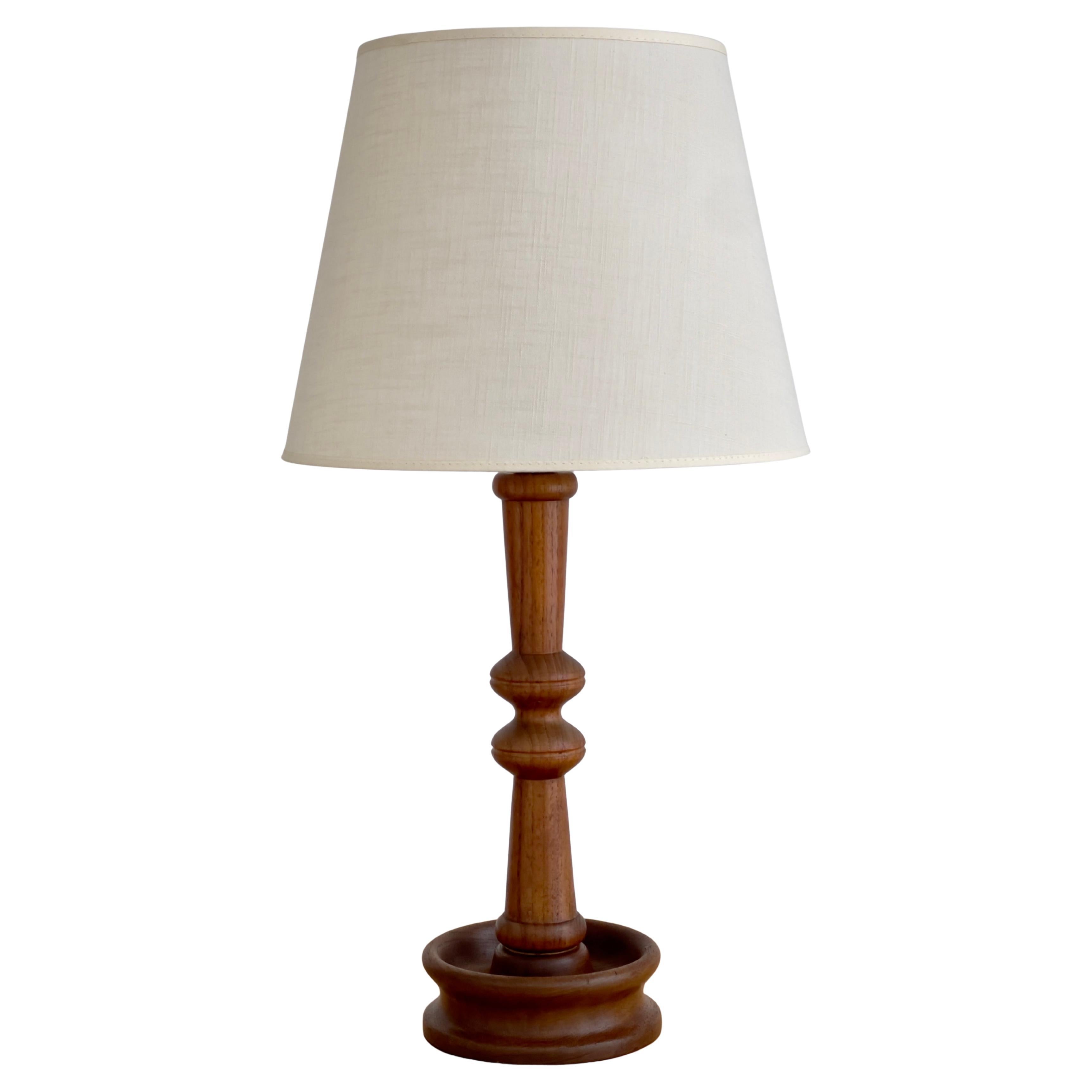 Danish modern table lamp in one solid piece of carved teak wood. Denmark 1950s