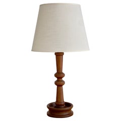 Danish modern table lamp in one solid piece of carved teak wood. Denmark 1950s