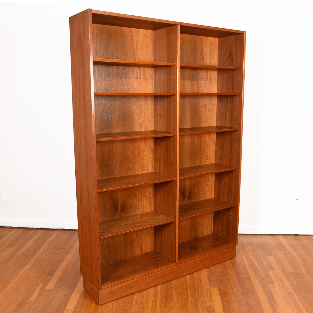 Danish Modern Tall Teak Adjustable Bookcase

Additional Information:
Material: Teak
This Danish modern bookcase will store your precious items and books in minimalist splendor.
Adjustable beveled teak shelves throughout — two middle shelves