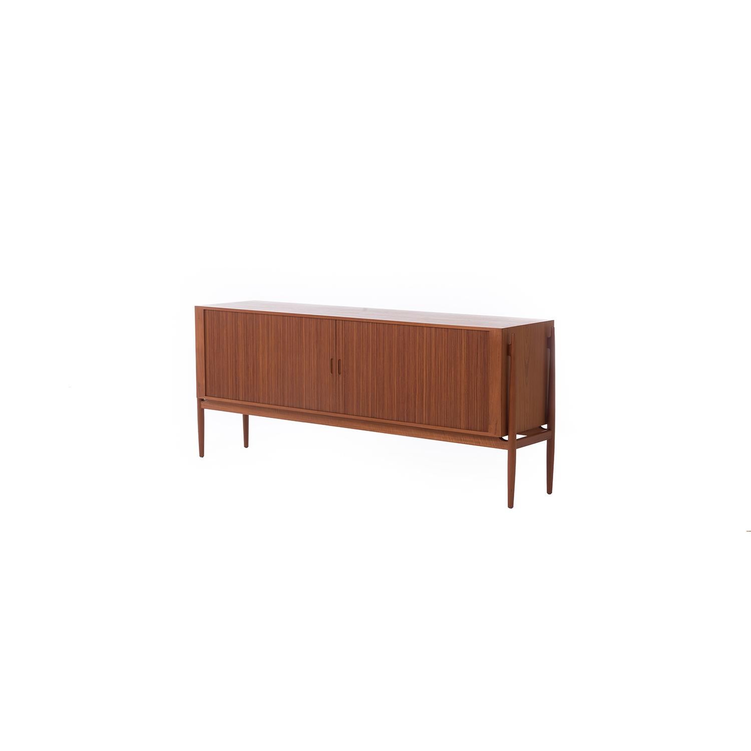 An exquisite example of what a Danish master cabinet maker can design and manufacturer. Known as the NV54 this Niels Vodder designed sideboard is in beautiful original condition. Beautiful book matched veneer case that is finished on all sides in a