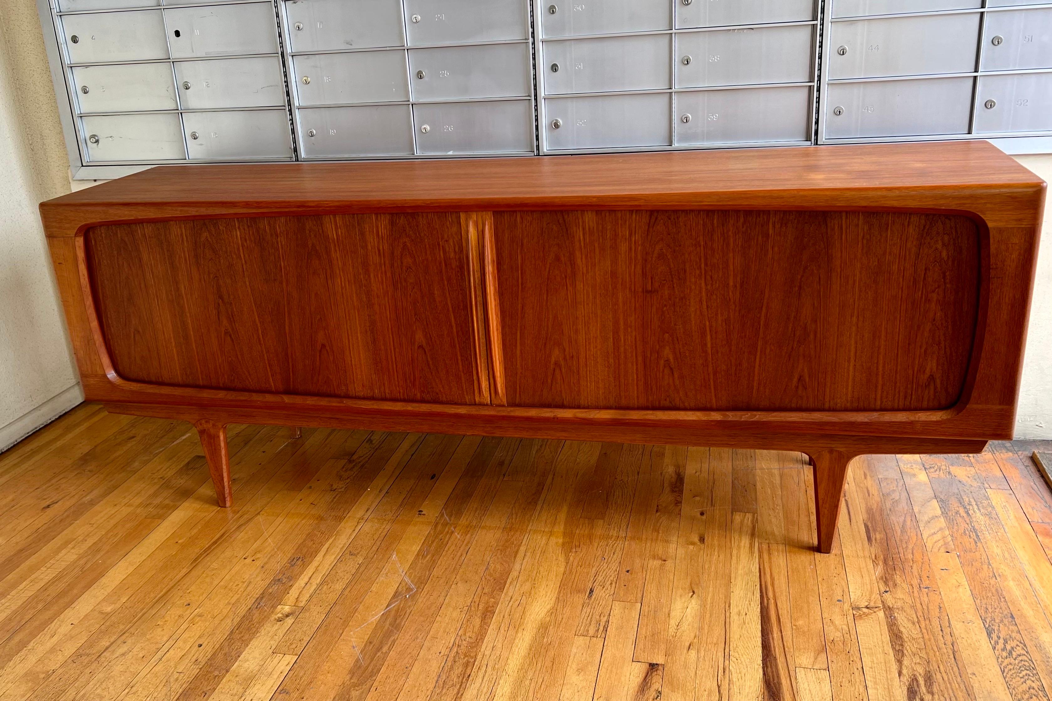 Beautiful and rare striking Danish modern tambour door teak credenza sideboard manufactured in Denmark in the 1960s. Rare model incredible craftsmanship lots of storage dovetail drawers and shelves, we refinished the piece with some light