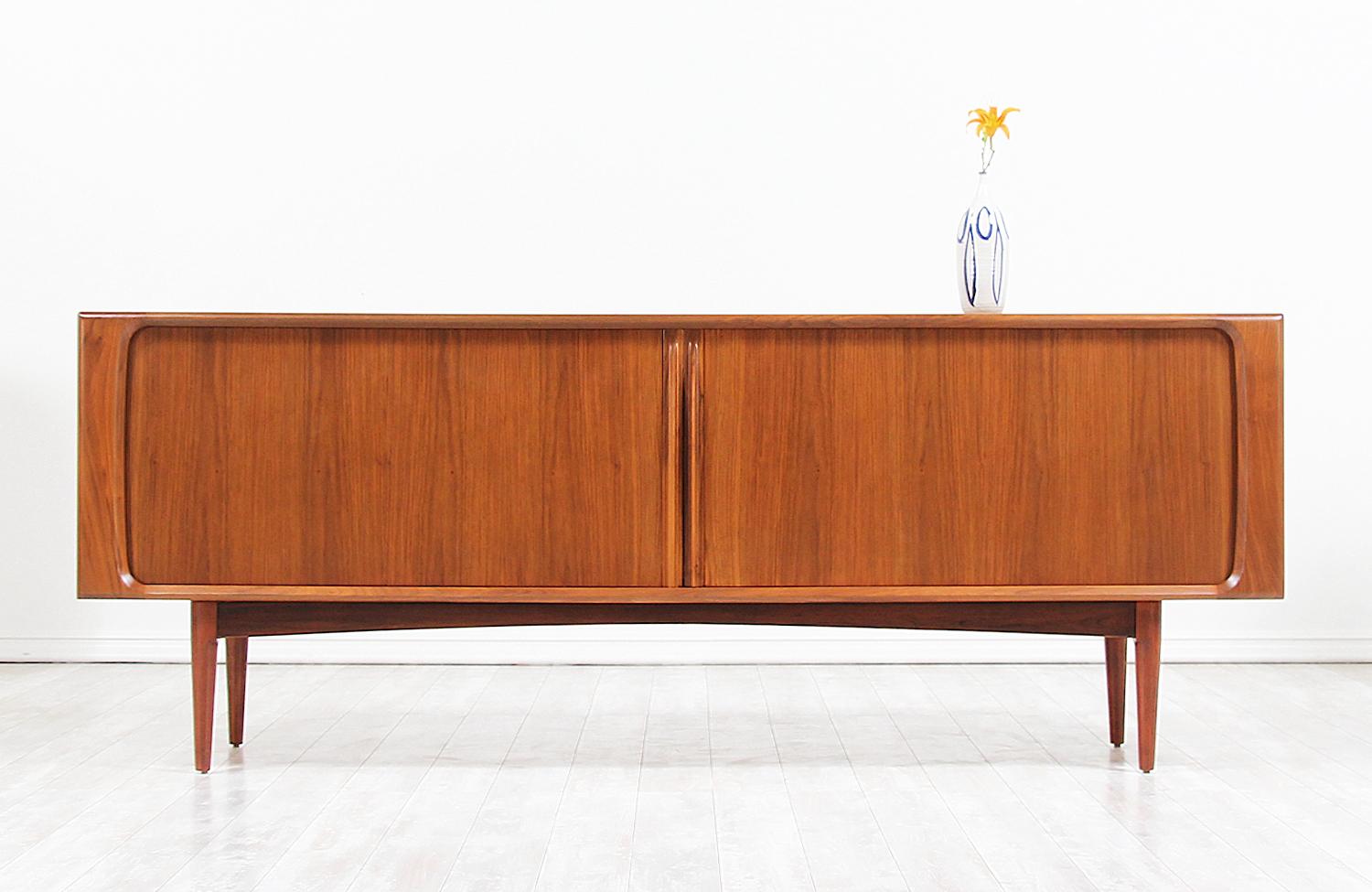 Mid-Century Modern credenza model No. 142 designed and manufactured by Bernhard Pedersen & Søn in Denmark in 1965. This Classic Danish modern and functional design features a solid walnut wood frame with tapered legs and gorgeous tambour doors with
