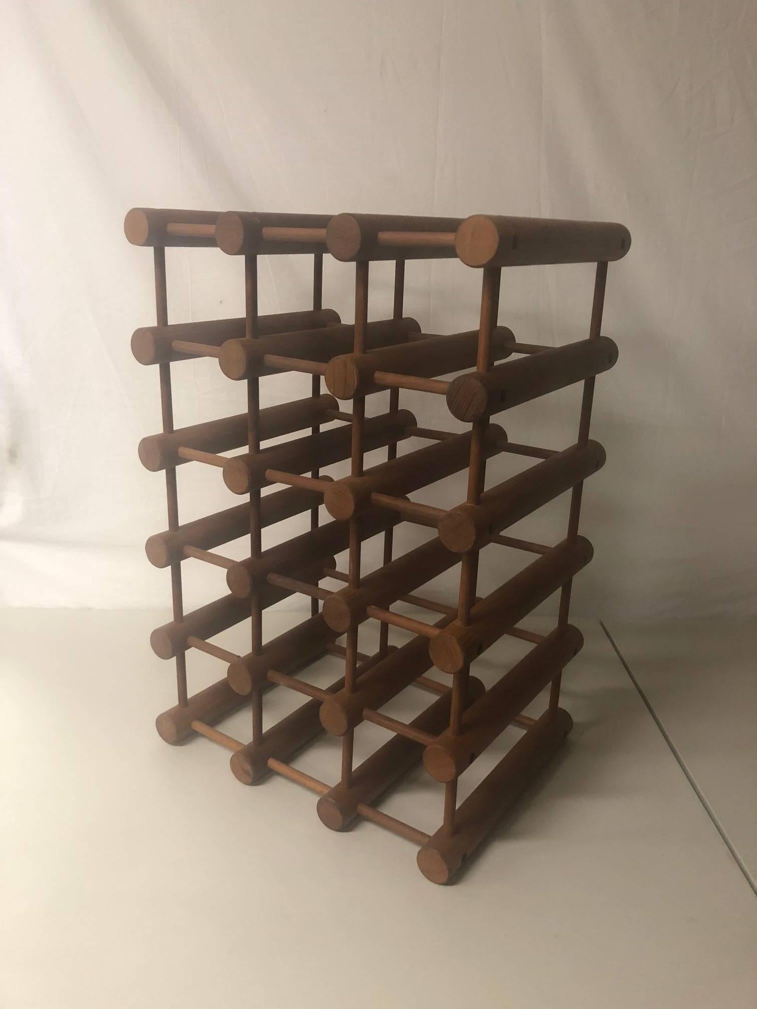 A very nice original Danish modern teak 15 bottle wine rack / holder signed by Nissen Langaa, circa 1960s. The piece is made of connecting teak dowels and is very heavy and solid and in very good vintage condition.