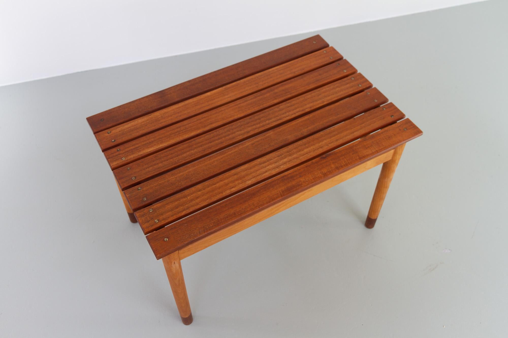 Danish Modern Teak and Beech Bench, 1950s.
Gorgeous small Danish Mid-century modern bench with slats in solid teak. Frame in beech with feet in teak. 
Versatile furniture that can used both inside, on the patio and even in the bathroom. Also