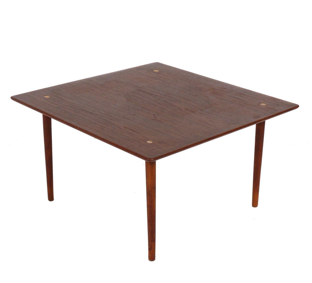 Table à café ou à cocktail moderne danoise en teck, Danemark, vers les années 1960. Il est fabriqué en teck magnifiquement grainé avec des accents en laiton. Il a été nettoyé et huilé au danois. 