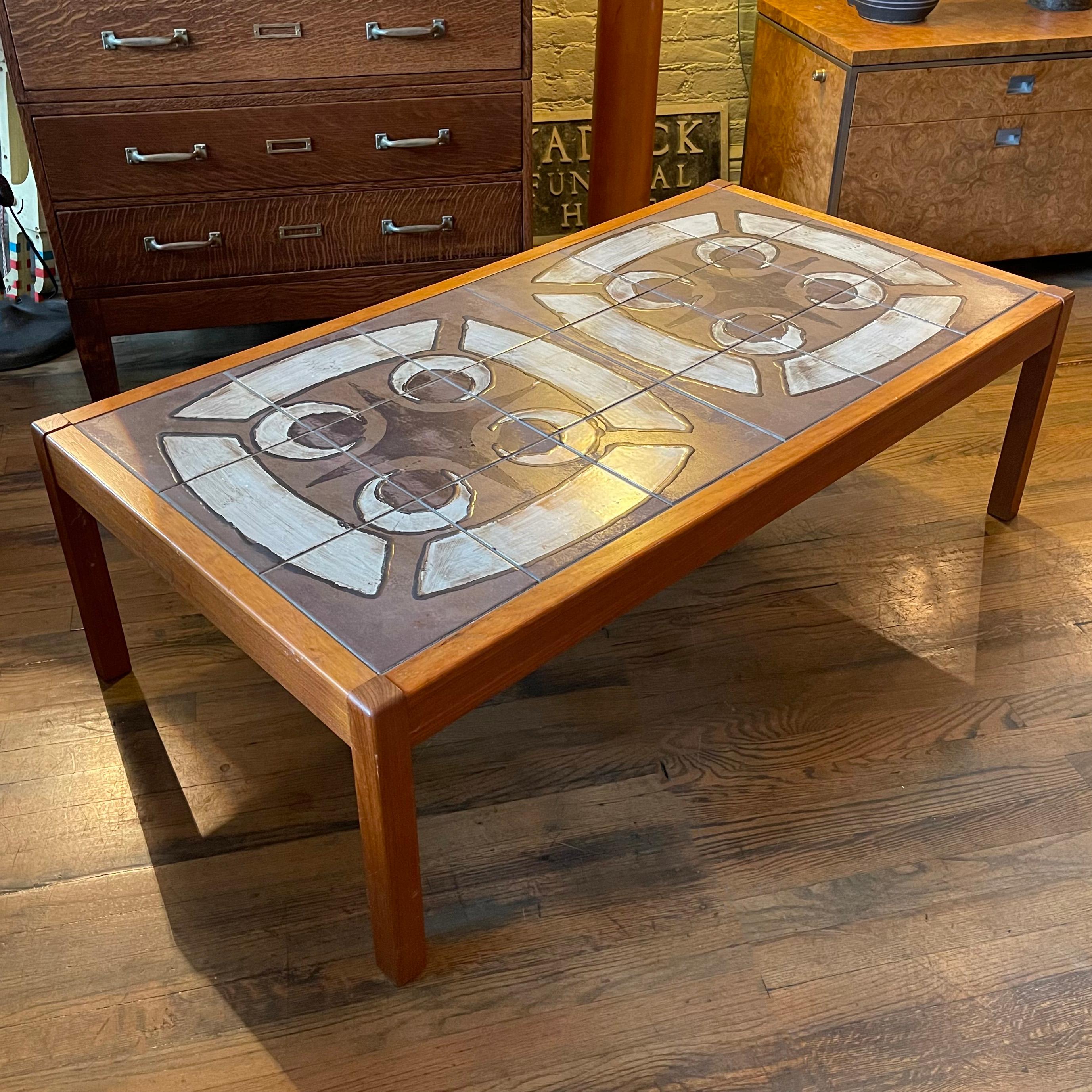 Large, Danish modern, coffee table features a hand-painted, ceramic, tile top framed in teak.