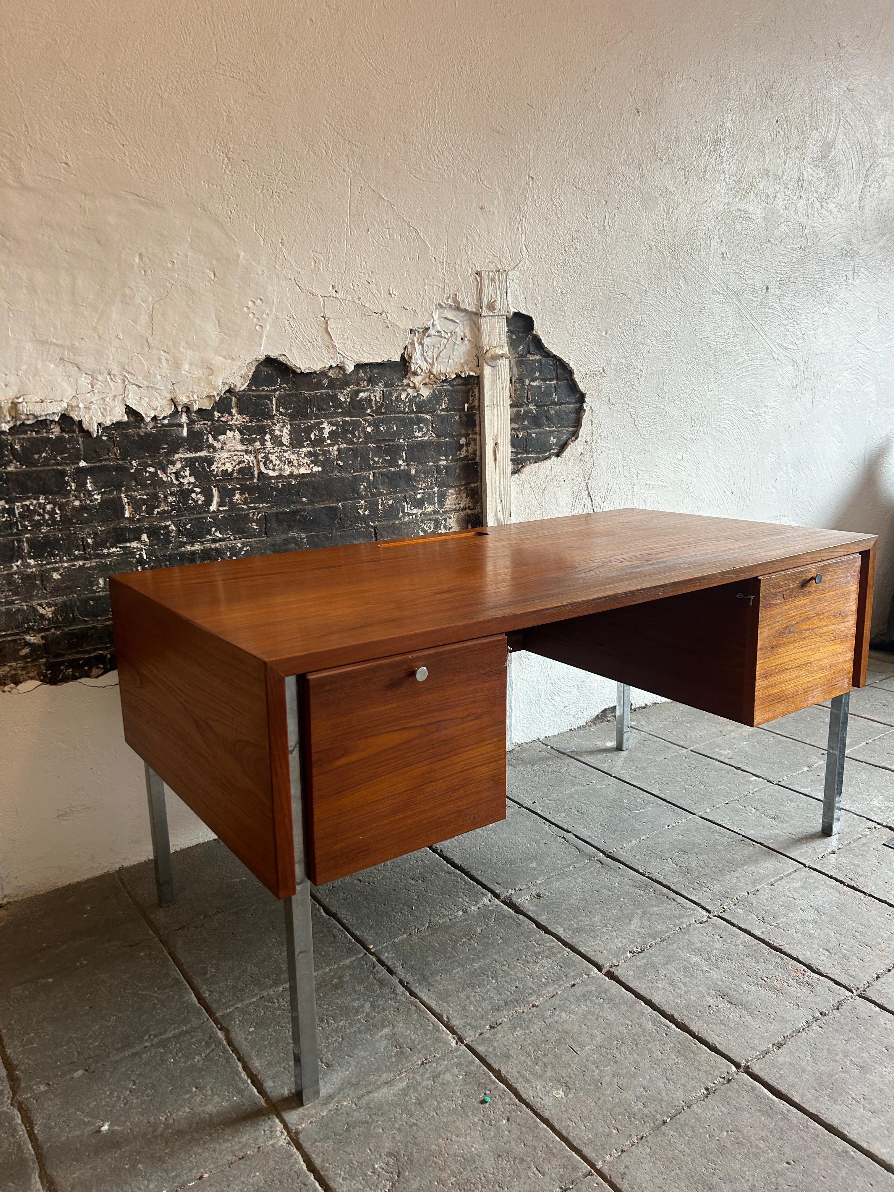 Unica scrivania moderna danese a 6 cassetti in teak e cromo di Sigurd Hansen Møbelfabrik. Scrivania cubica in teak molto minimalista con gambe in tubo quadrato cromato e pomelli cromati. Questa scrivania è dotata di (2) ante di armadio verso il