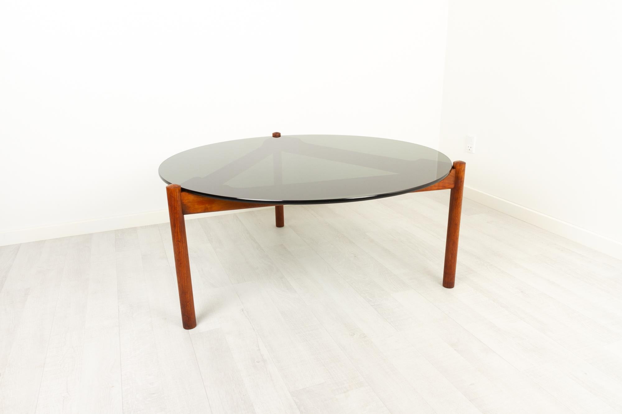 Danish modern teak and glass coffee table by Komfort, 1960s
Vintage Mid-Century Modern coffee table made by Komfort in the 1960s, and therefore most likely designed by Sven Ellekær.
Three legged frame in solid teak with round legs. Beautiful