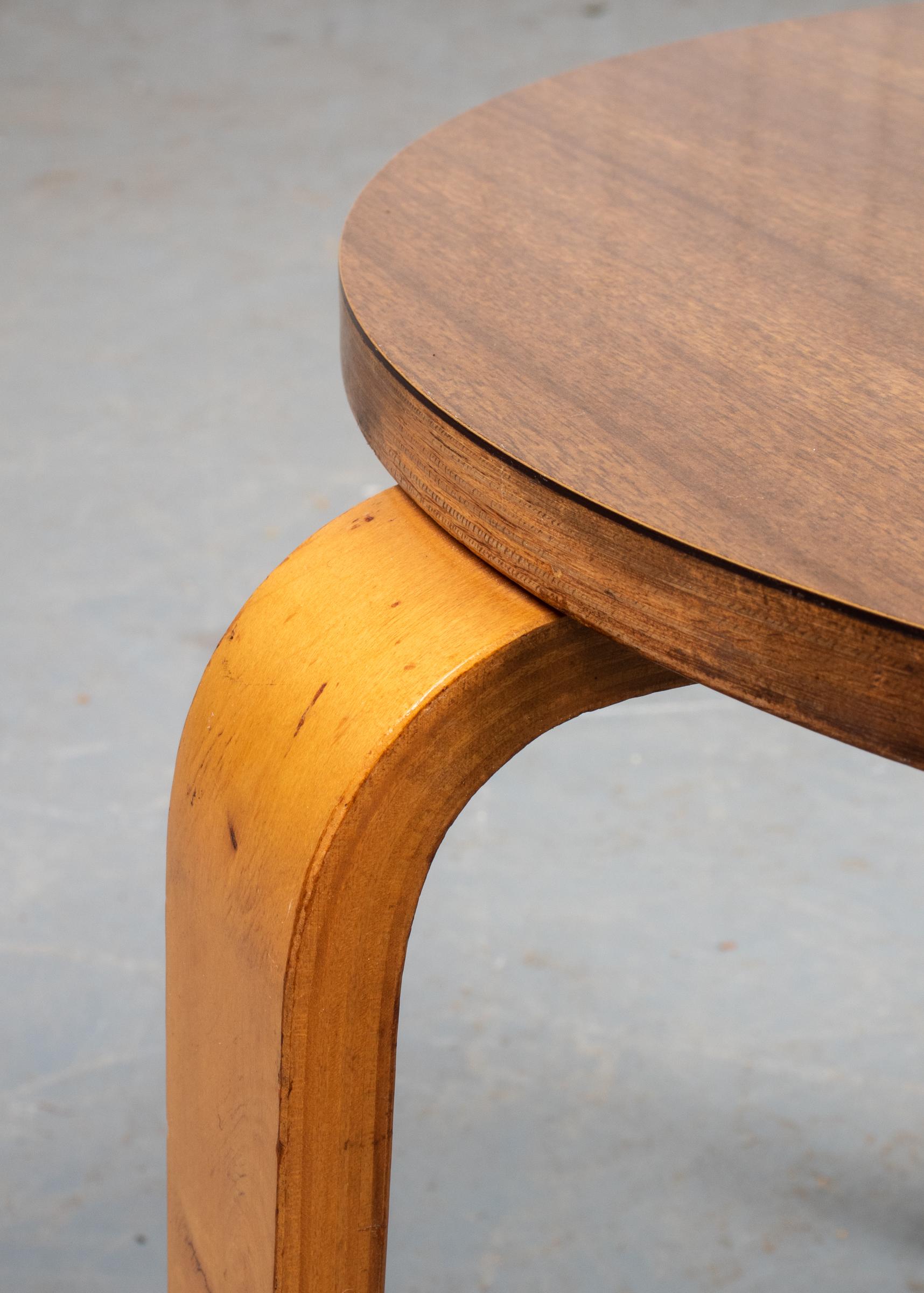Danish Modern side / occasional three leg table, after the Model 60 stacking stool by Avar Aalto (Finnish 1898-1976), the round laminate top over three L-form teak legs. Measures: 15.5