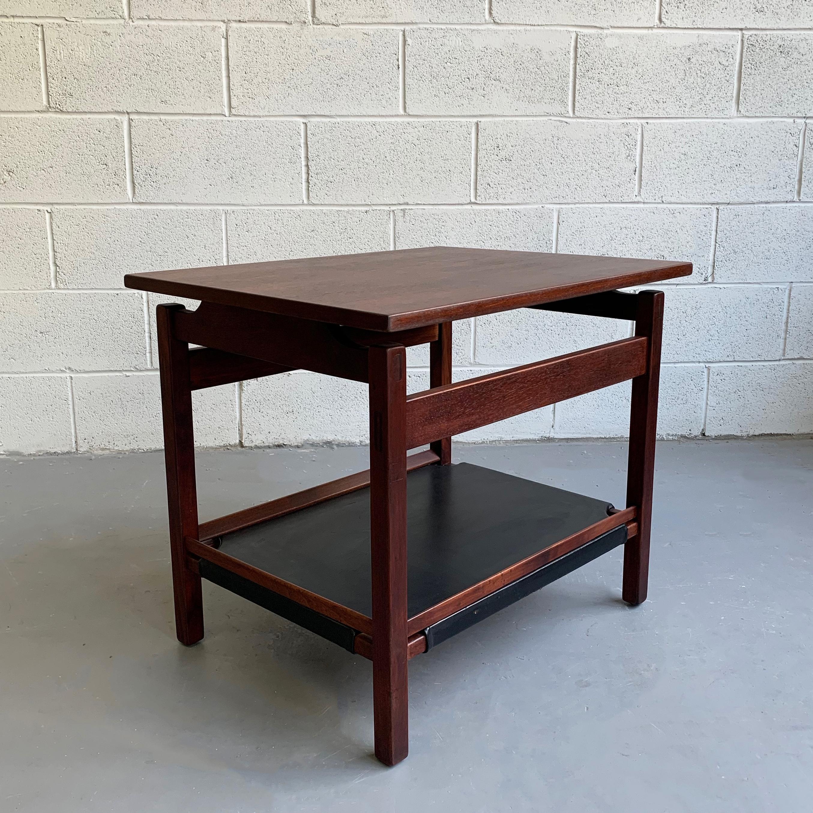Danish modern, teak side table features a floating top and lower leather tier perfect for magazines.