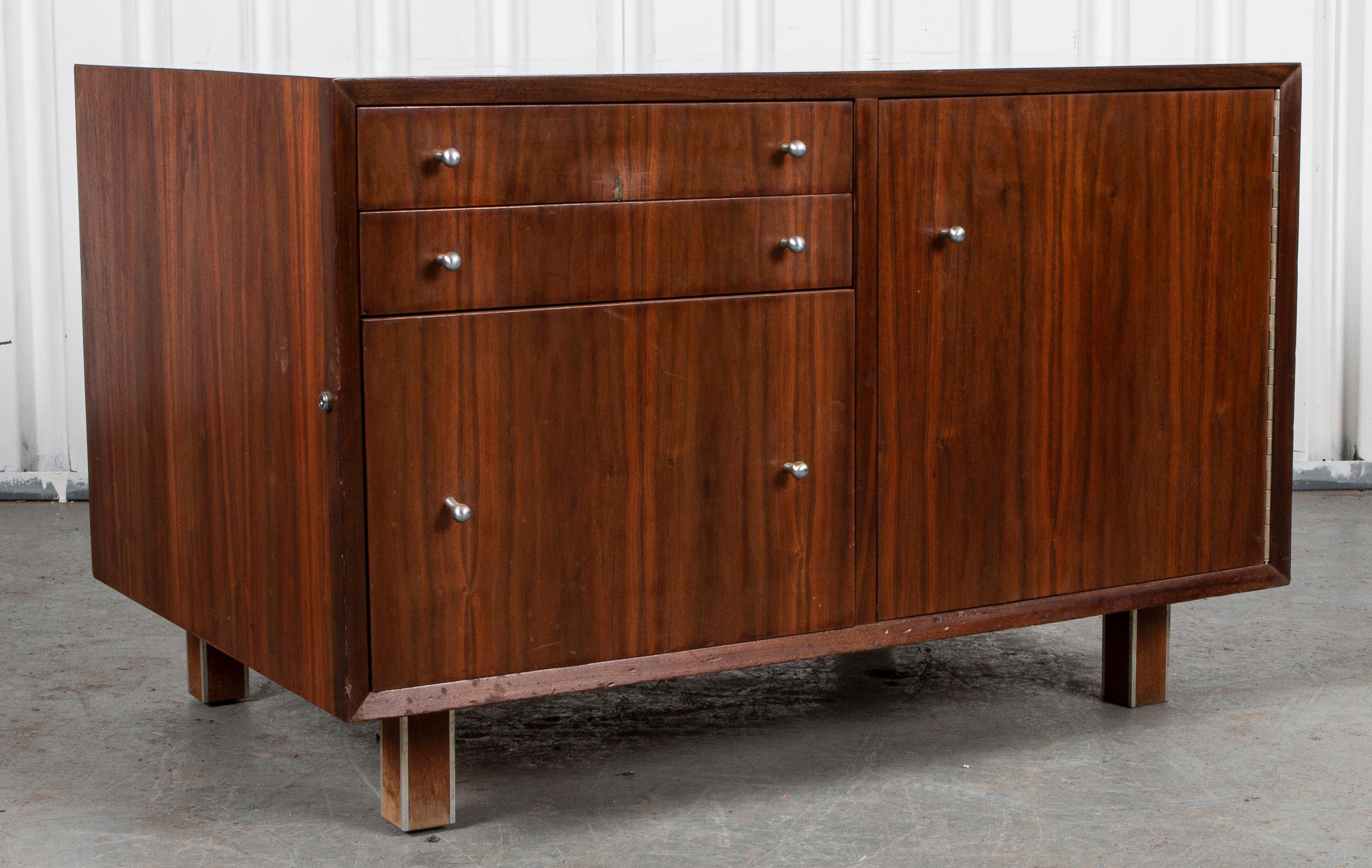 Danish Modern teak and white laminate-mounted credenza with three drawers opposite a cabinet door with steel pulls and steel-mounted square legs.

Dealer: S138XX