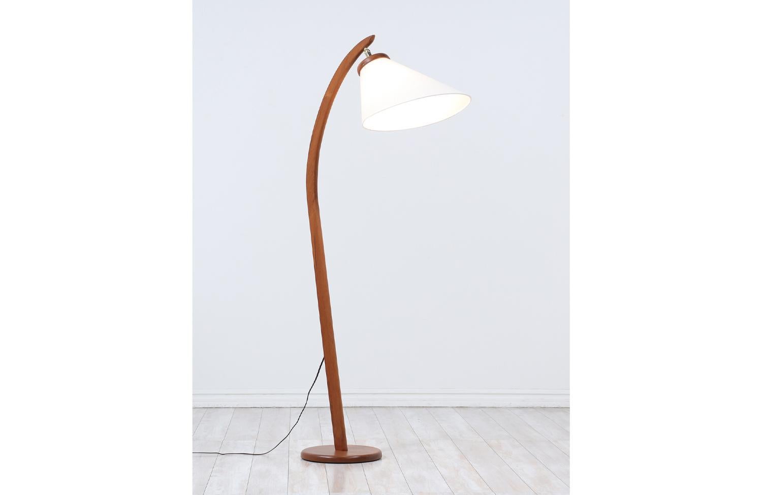 Danish Modern teak arch floor lamp with articulating cone shade.