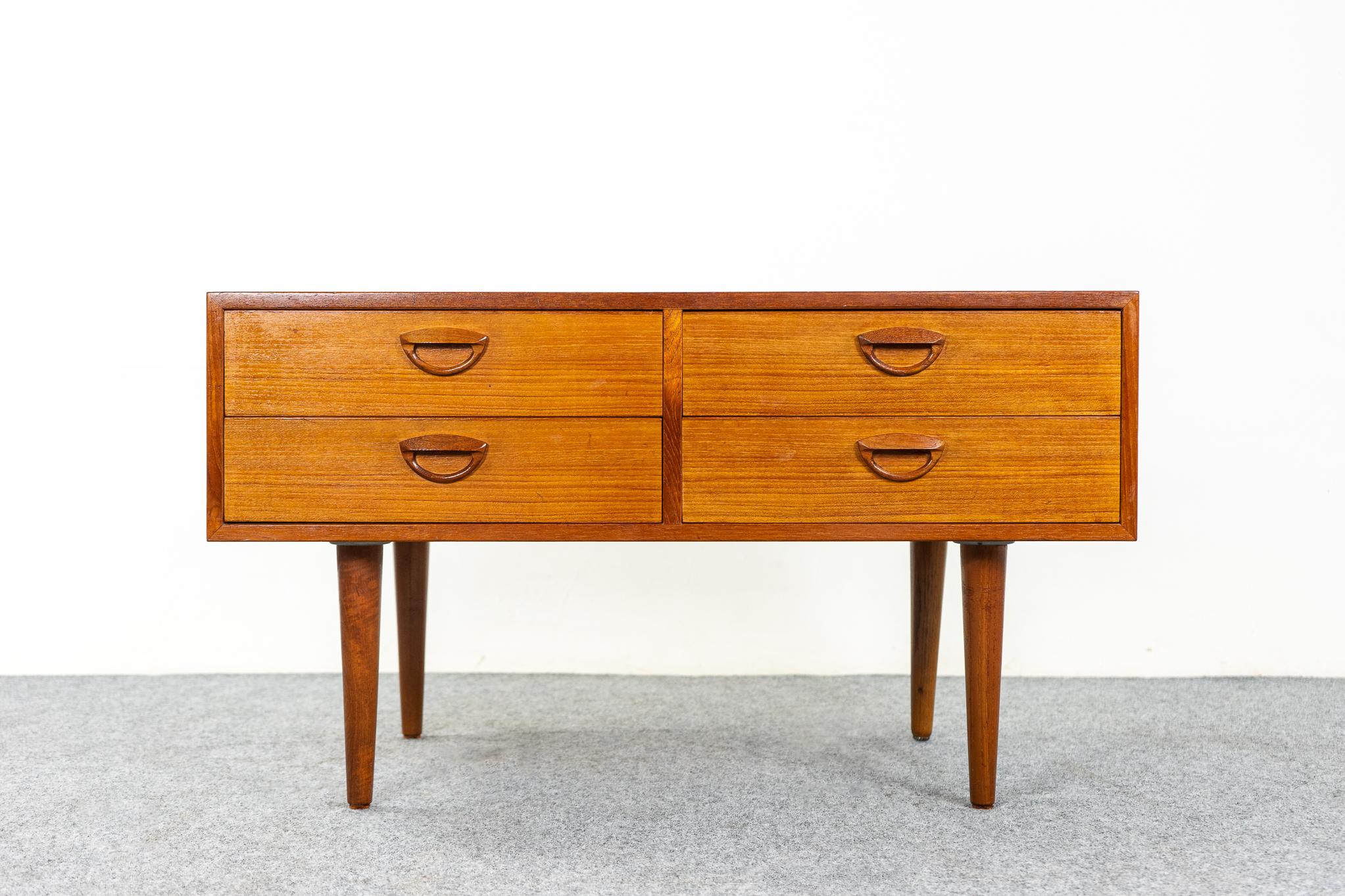 Teak Danish modern bedside table by Kai Kristiansen, circa 1960's. Beautifully veneered case rests on slender, tapered legs. Sleek drawers with dovetail construction and sweet handles. Add the extra storage you've always needed!

Please inquire for