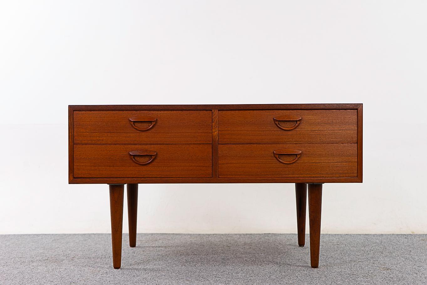 Teak Danish modern bedside table by Kai Kristiansen, circa 1960's. Beautifully veneered case rests on slender, tapered legs. Sleek drawers with dovetail construction and sweet handles. Add the extra storage you've always needed!

Please inquire for