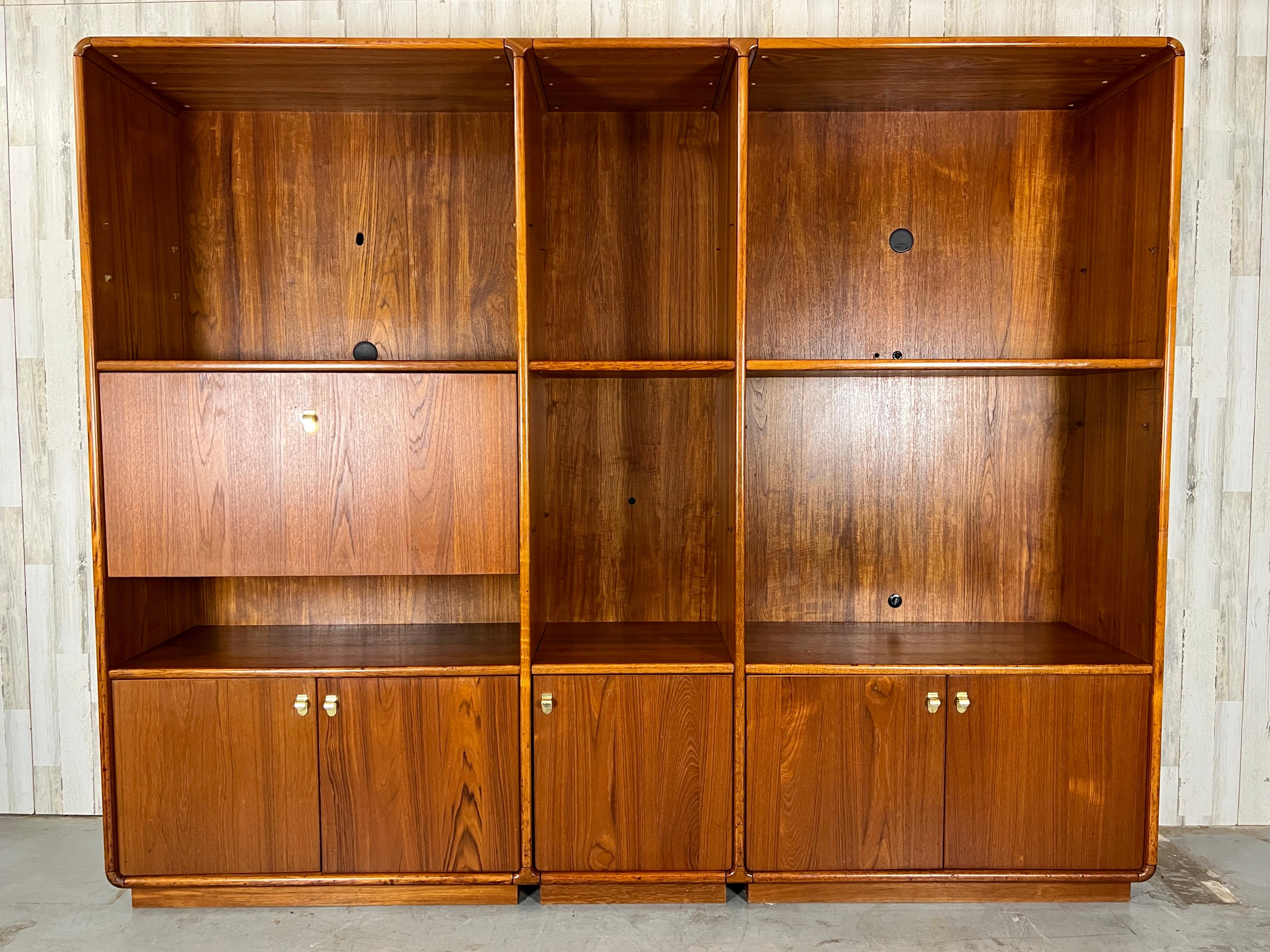 Large teak media cabinet /bookcase with drop down dry bar or can be used as a desk 33” high work surface. 
Some shelves are movable. 
Big compartments
28 1/2 high 39 1/4 wide 
Middle compartment
58 high 19 3/4 wide
Shelves 17 1/2 deep.