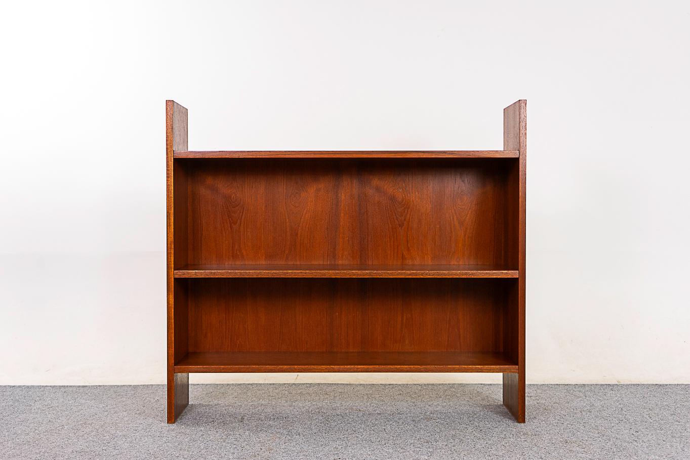 Teak mid-century bookcase, circa 1960s. Low profile design with adjustable shelf, can be hung at 7 different heights. A perfect condo sized storage solution.

*6 available, construct a library wall!

Please inquire for international shipping rates.