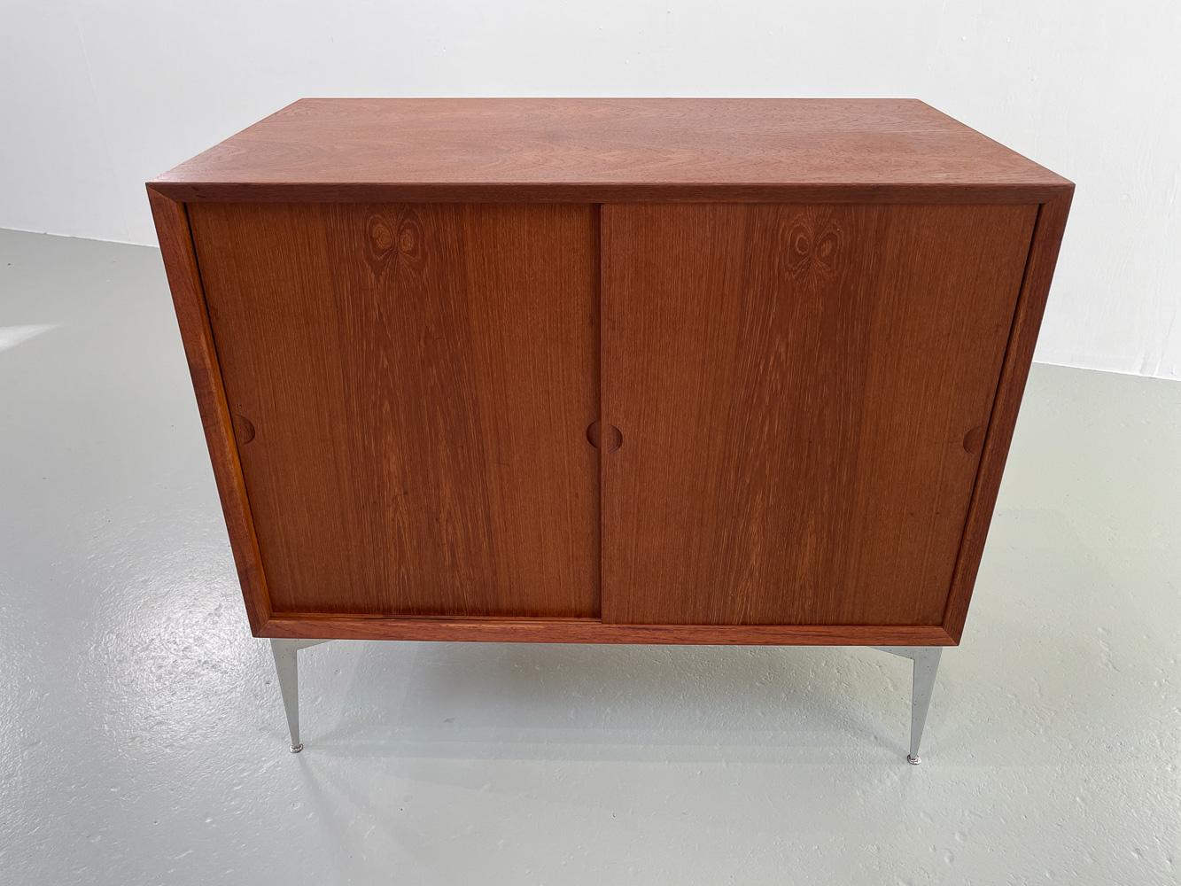 Danish Modern Teak Cabinet by Poul Cadovius for Cado, 1960s.
Vintage Scandinavian Mid-Century Modern teak sideboard with double sliding doors. Standing on four original and rare Cado metal legs. Inside is divided into two compartments. One with