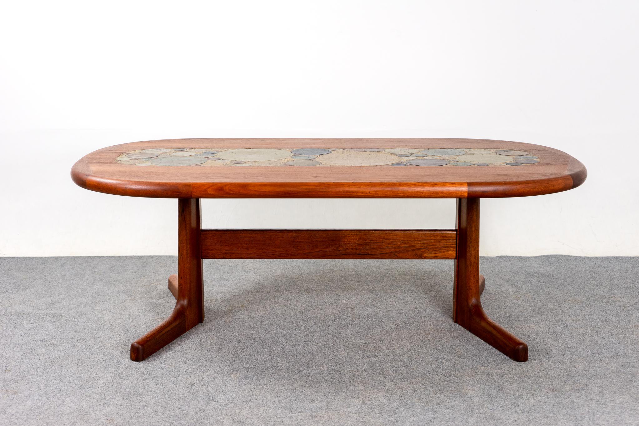 Teak and ceramic Danish modern coffee table by Tue Poulsen, circa 1970's. Robust coffee table with unique solid scalloped edge. Centre of the table has handmade circular tiles in a lovely pattern, think built-in trivet/coasters! Cross support