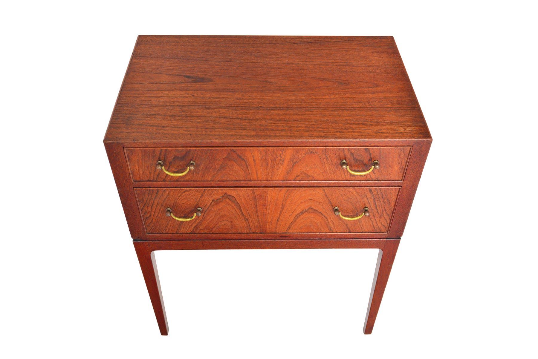 This Danish modern two drawer teak chest is a beautiful blend of modern lines and traditional details. Expertly constructed joinery is highlighted by routed detailing. Each drawer is adorned with original brass pulls. Perfect for use in an entryway
