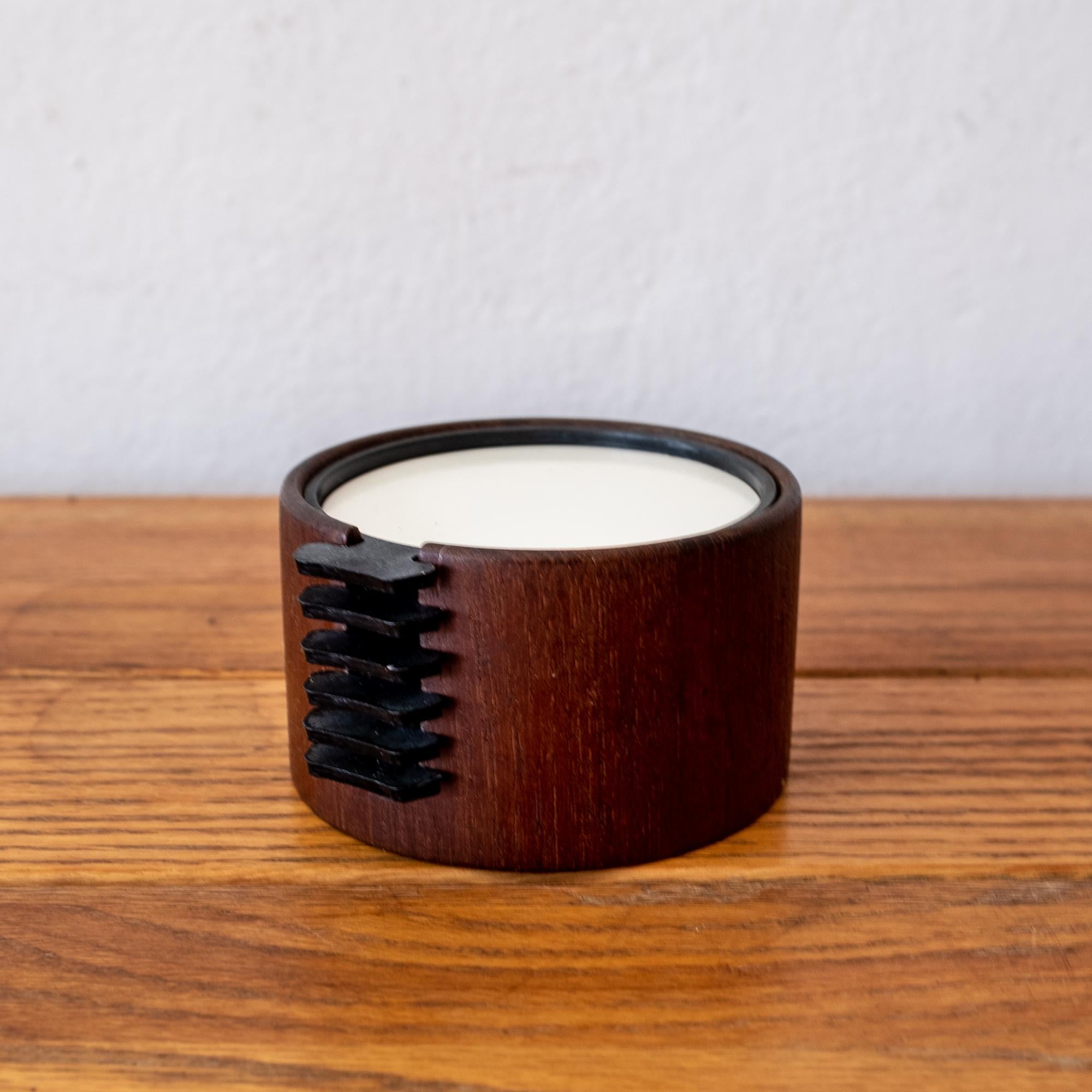 Danish modern teak coaster set with six multi-color coasters that store in a teak cylinder. Stamped Denmark.