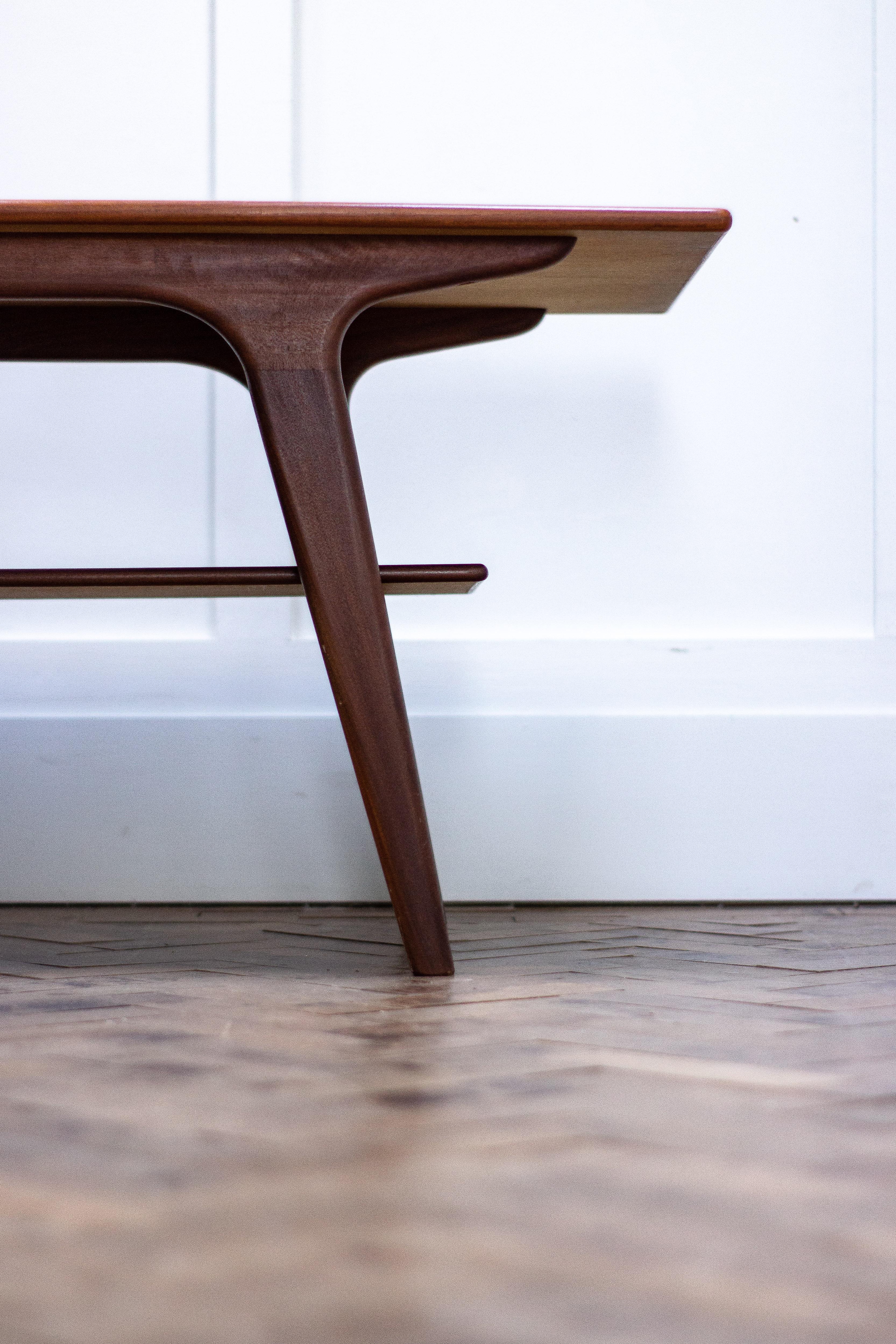 Danish modern coffee table in teak with splayed legs and single shelf, 1960s.

Measures: Height 54cm
Length 150cm
Depth 55cm.