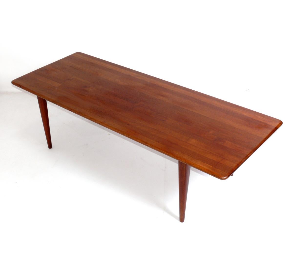 Danish Modern teak coffee table, Denmark, circa 1960s. This table is currently being refinished and will look incredible when completed. The price noted includes refinishing. It measures an impressive 64.75