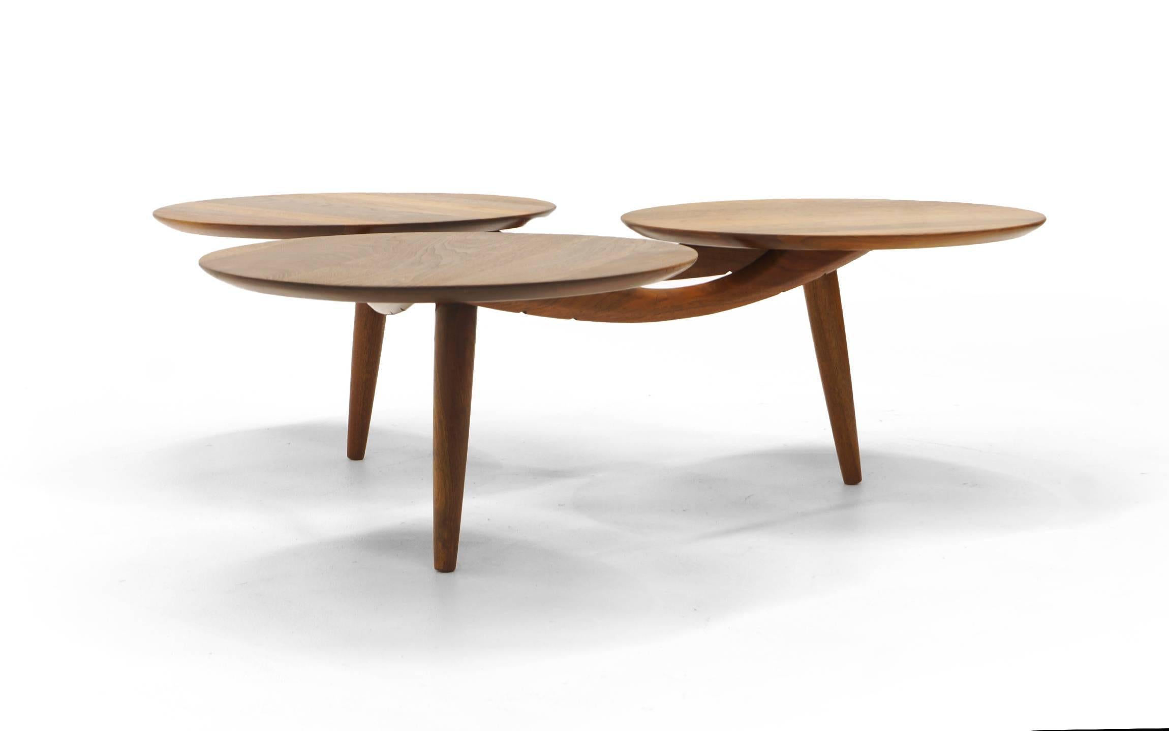 Unusual and striking Danish solid teak coffee table. Three round teak surfaces attached to a teak base. Overall forms a triangular footprint. Expertly restored and refinished.