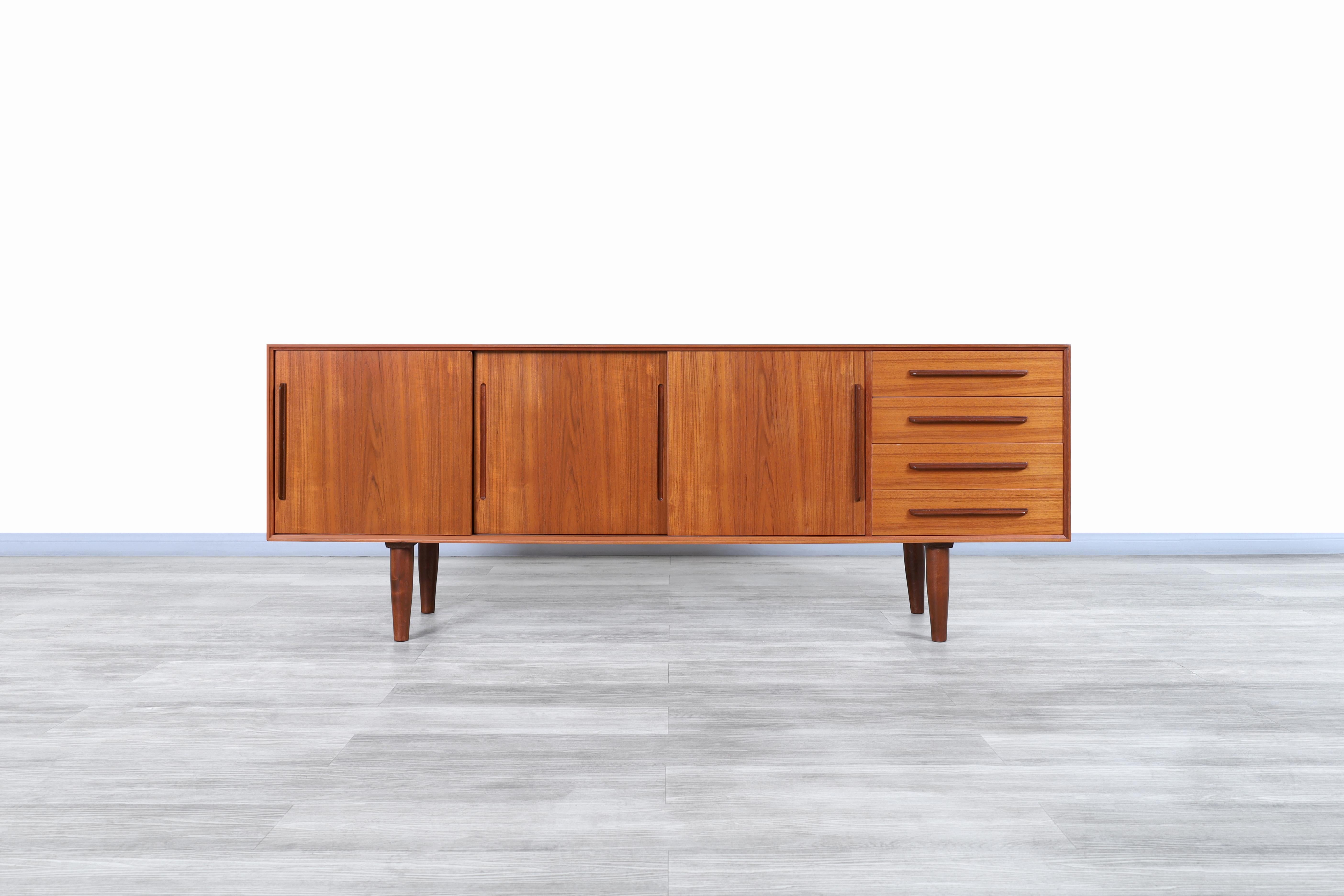 Stunning Danish modern teak credenza manufactured in Denmark, circa 1960s. This credenza is built from the highest quality teak wood, which, thanks to the figures given by the grains of the wood, offers a unique contrast throughout the entire case.