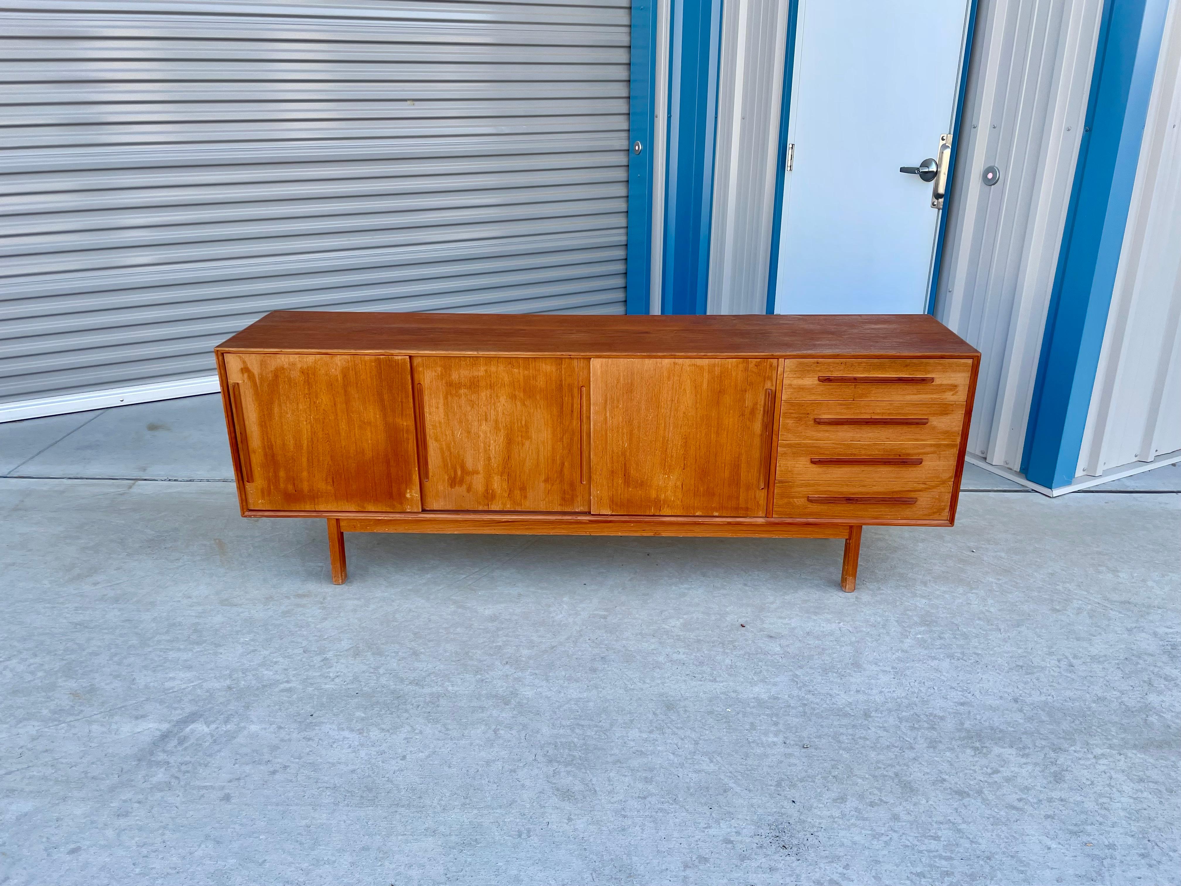 This beautiful Danish modern credenza was designed and manufactured in Denmark in the 1960s. This credenza is built from the highest quality teak wood, which, thanks to the figures given by the grains of the wood, offers a unique contrast throughout