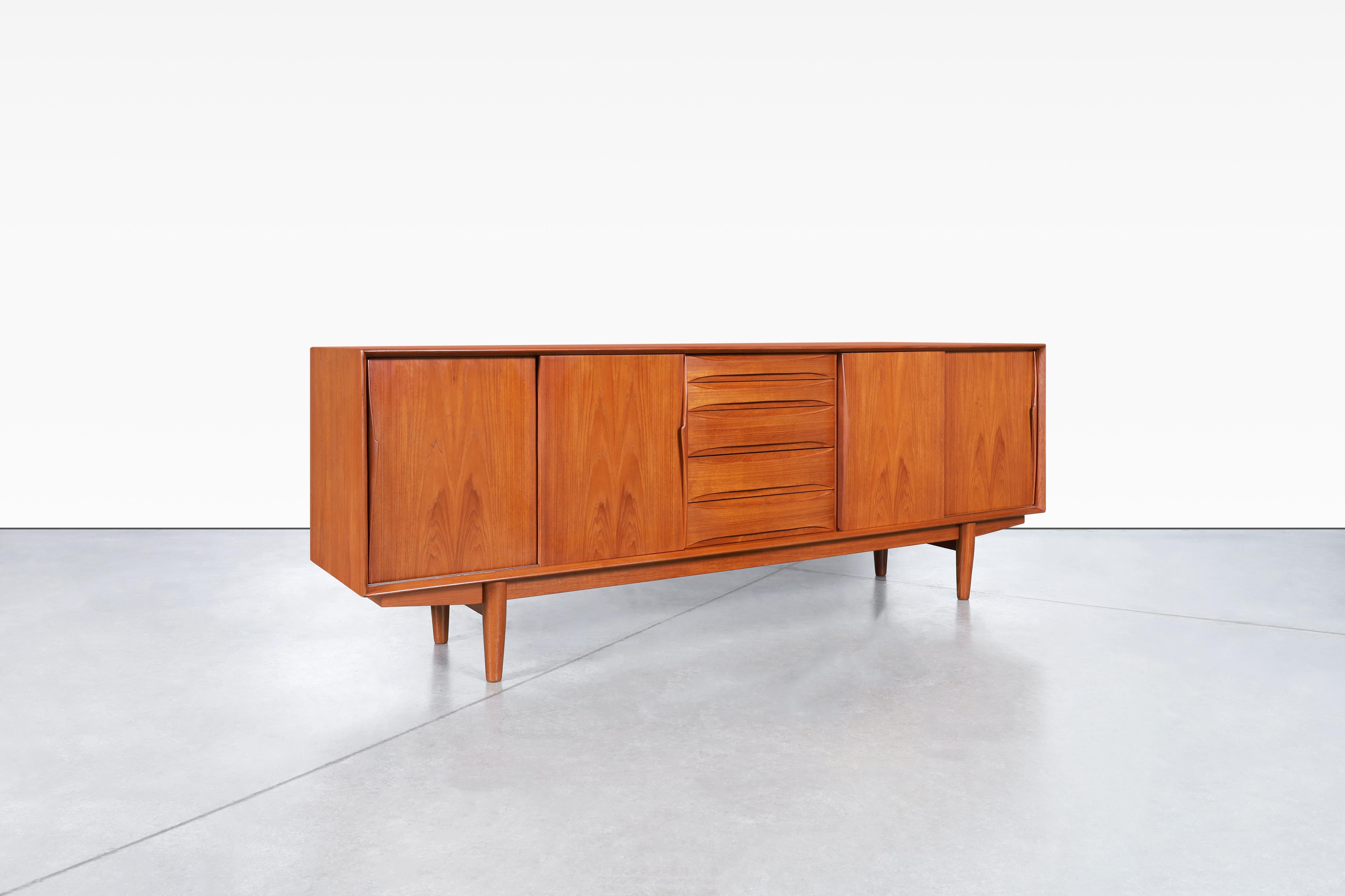 Stunning Danish modern teak credenza model 7738, attributed to Arne Vodder and produced Skovby Møbelfabrik in Denmark, circa 1960s. This skillfully crafted credenza, also known as model #7738, features four sliding doors with adjustable shelves and