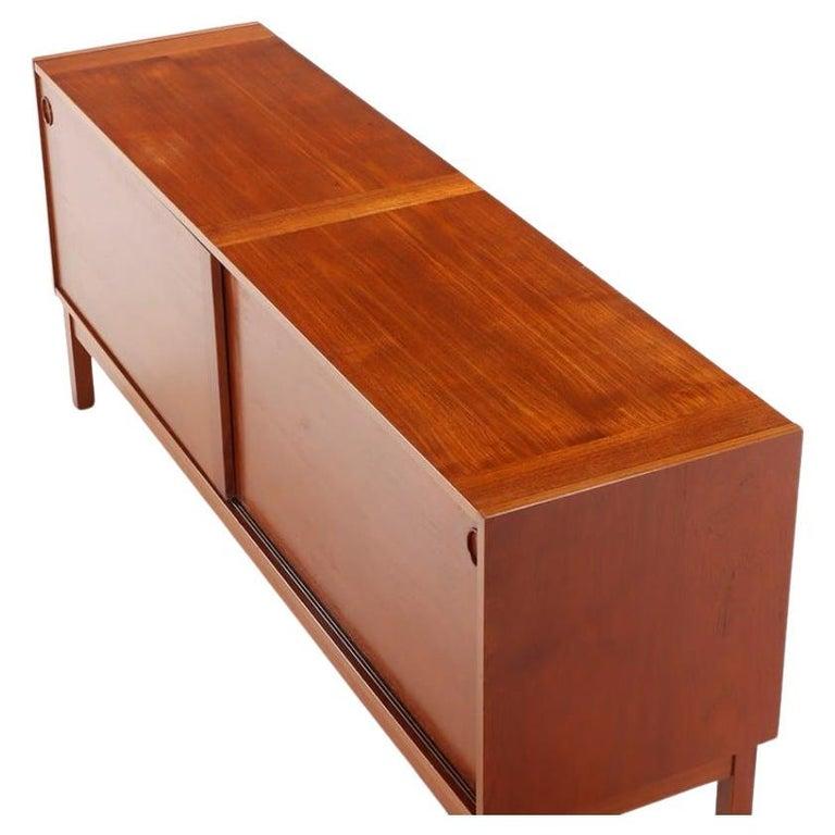 Danish modern credenza with sliding doors and 3 adjustable shelves by ib Kofod Larsen. Circular door slide handles. Minimalist design.
Made By Faarup Møbelfabrik made in Denmark. Located in Brooklyn NYC

Dimensions 72” x 19” x 30” high
