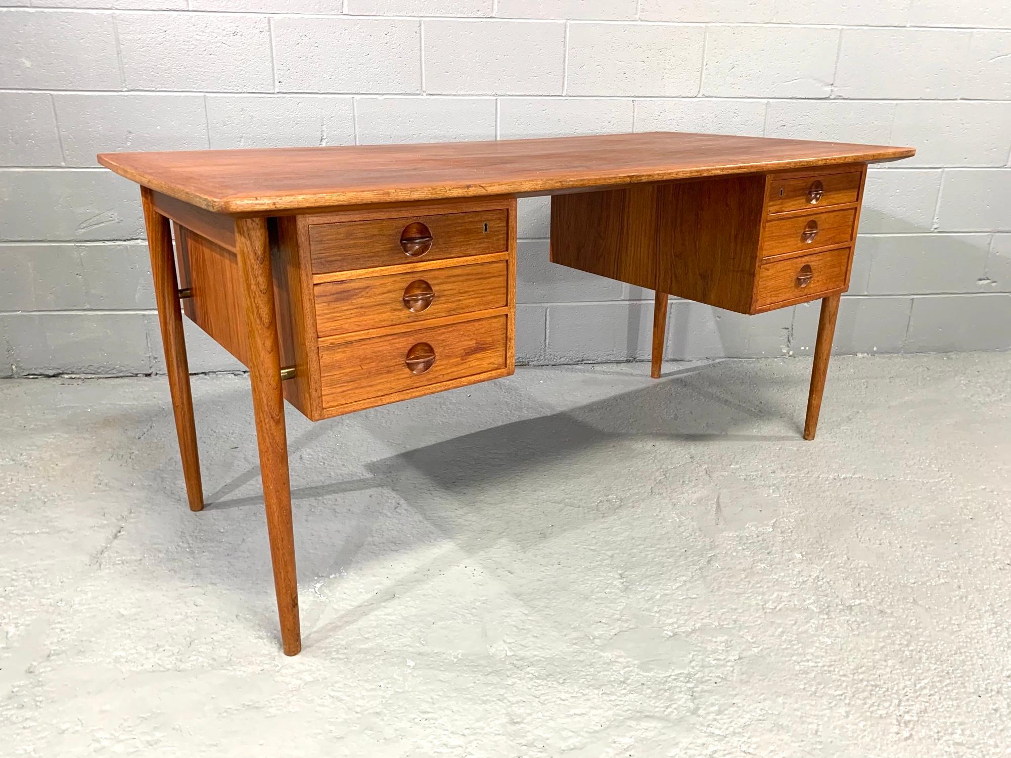 Nicely crafted Danish modern, midcentury desk with floating top and hanging case design with round teak drawer pulls attributed to Kai Kristiansen.