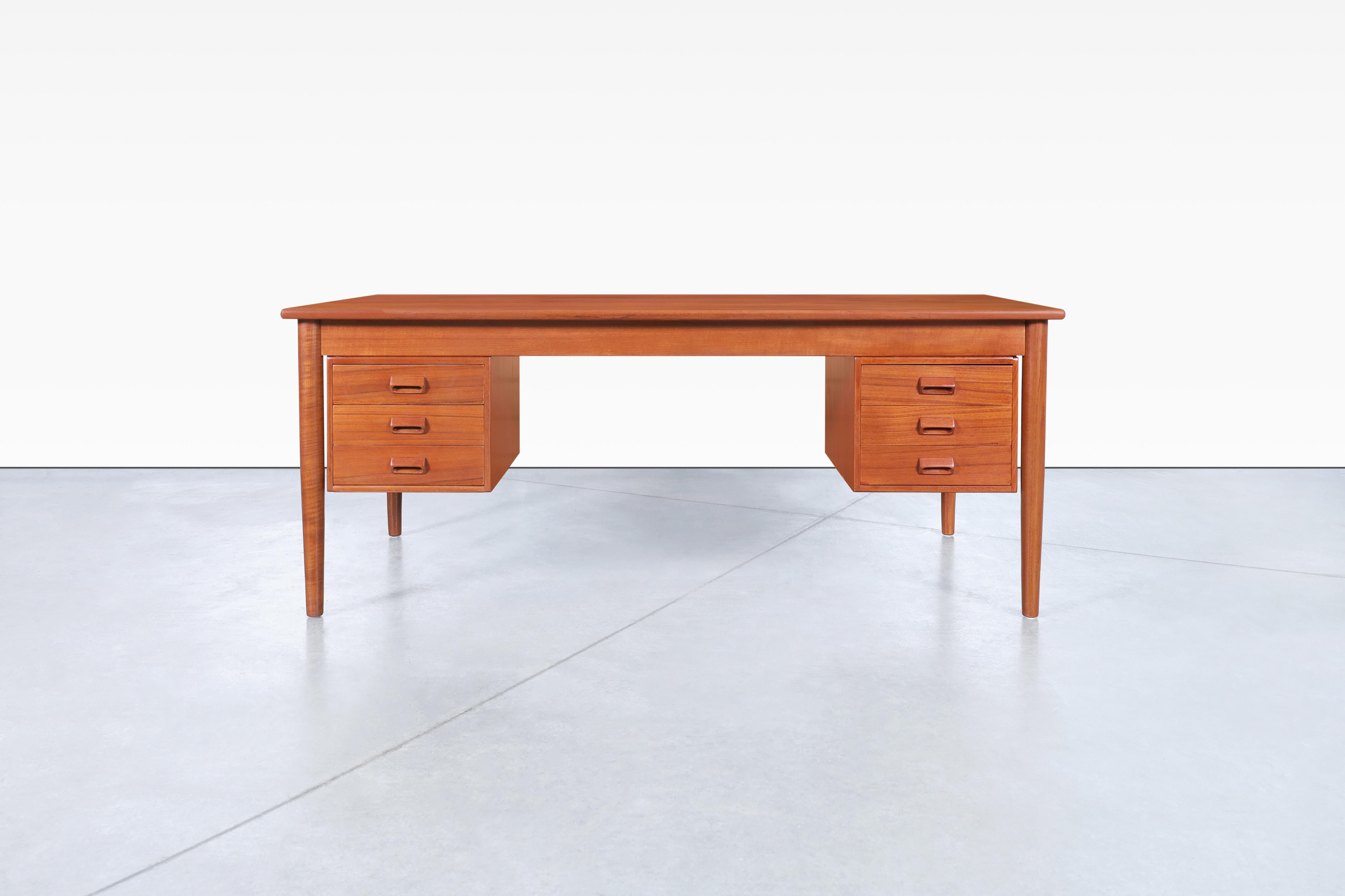 Stunning Danish modern teak desk also known as Model #130 designed by Børge Mogensen for Søborg Møbler in Denmark, circa 1950s. This exquisite desk features a versatile design that caters to your needs while flaunting a symmetrical structure.